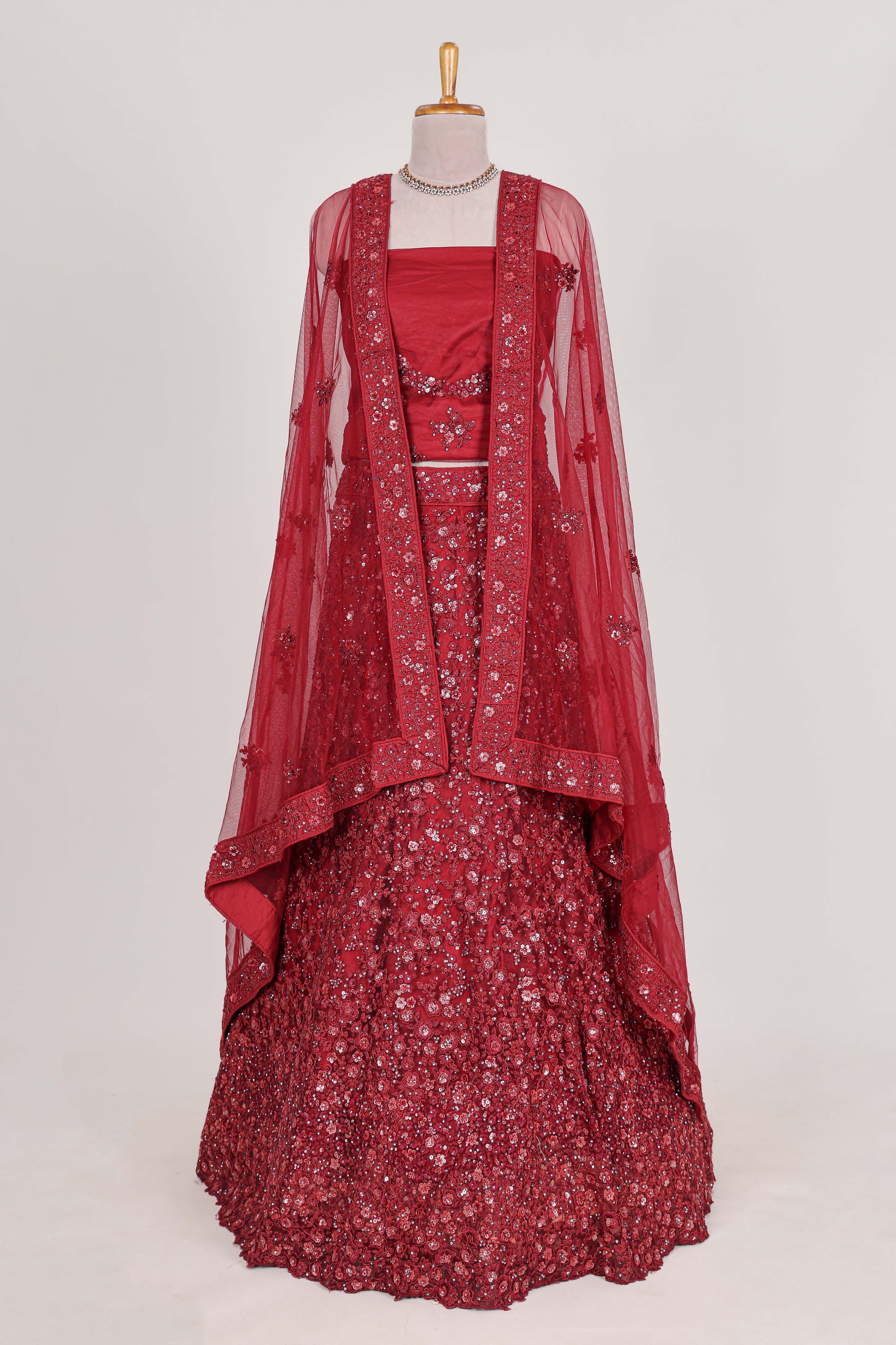 Beautiful net lehenga adorned with intricate embroidery Paired with a matching net shawl perfect for weddings and special occasions