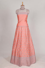 Peach satin lehenga featuring delicate embroidery with a bordered design paired with contrast shawl