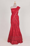 Bright red net lehenga intricate embroidery andpaired with a matching embroidered blouse