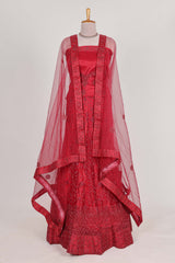 Bright red net lehenga intricate embroidery andpaired with a matching embroidered blouse
