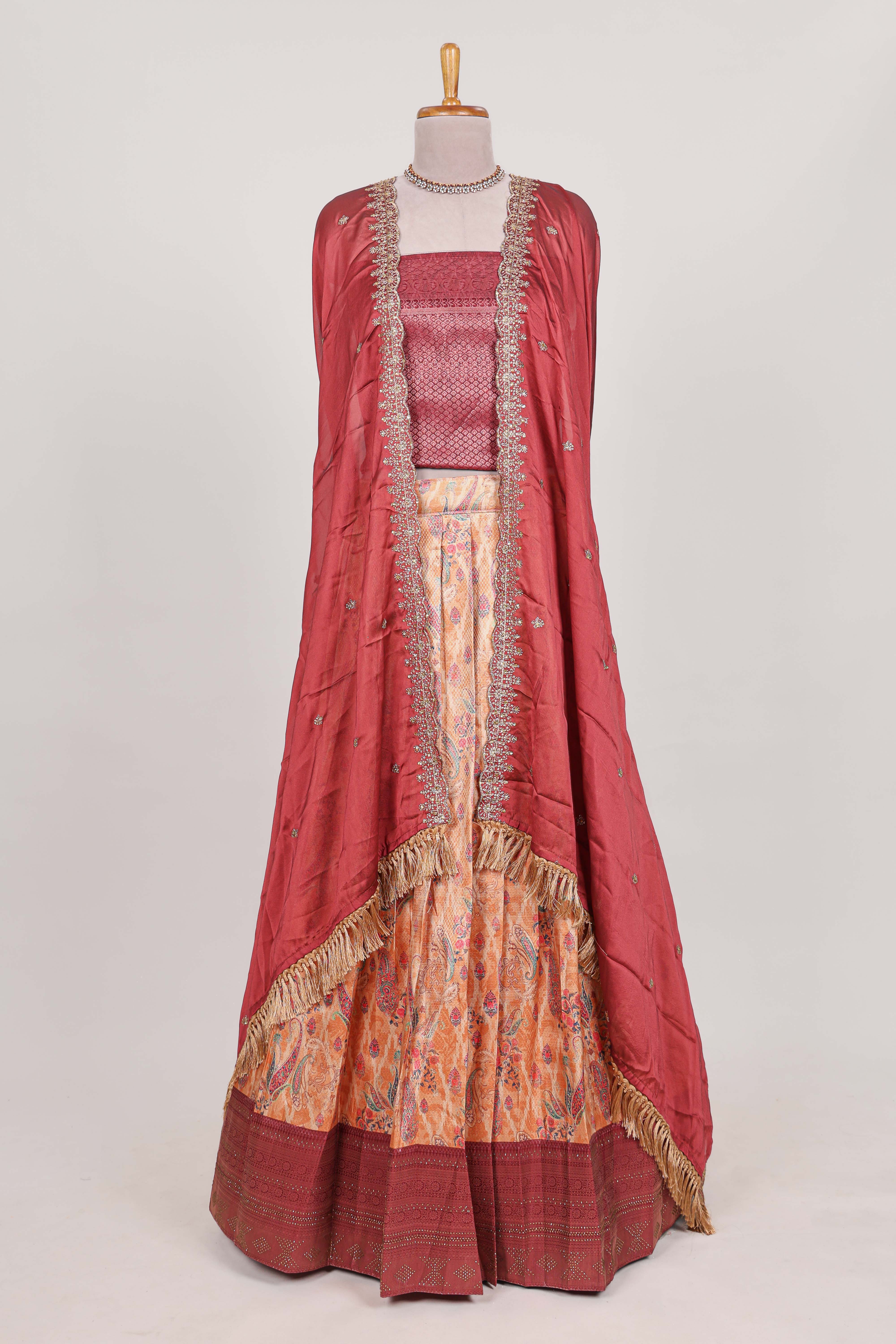 Rani pink tissue lehenga featuring intricate thread weaving details with a beautiful contrast border Paired with a brocadeshawl