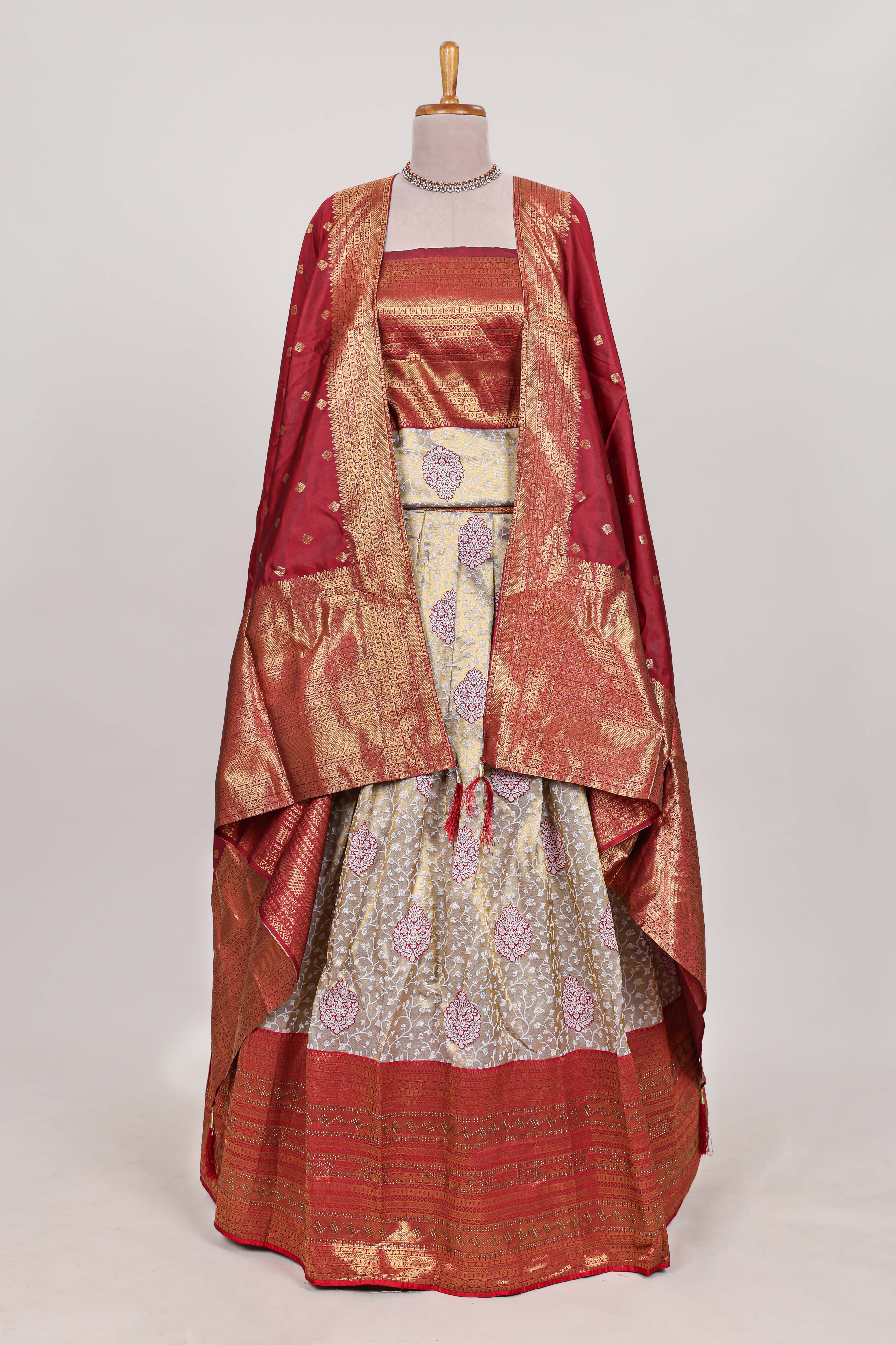 Red tissue lehenga featuring intricate thread weaving details with a beautiful contrast border Paired with a brocadeshawl