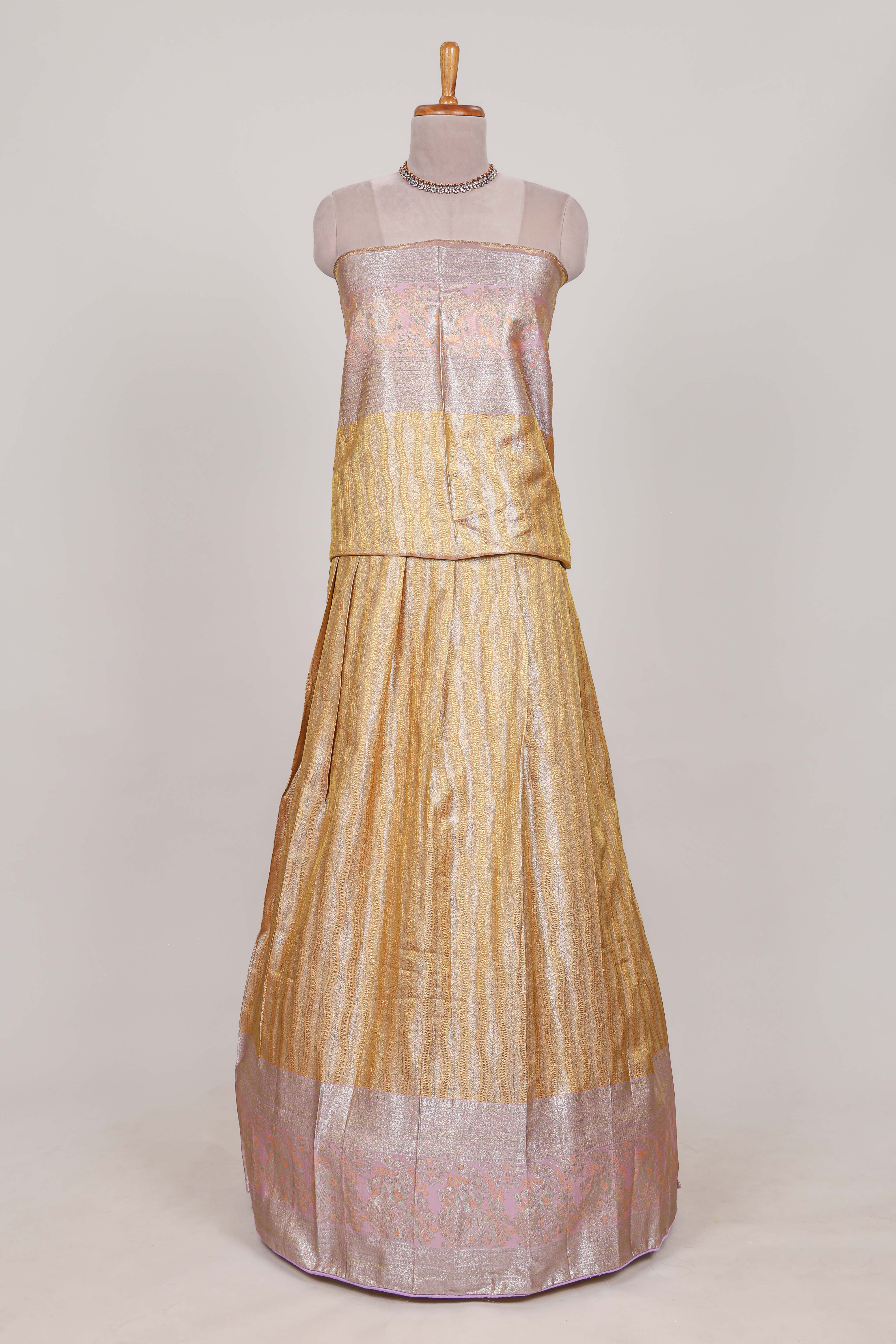 Cream tissue lehenga featuring elegant vertical line patterns with a beautiful contrast border Paired with a matching shawl