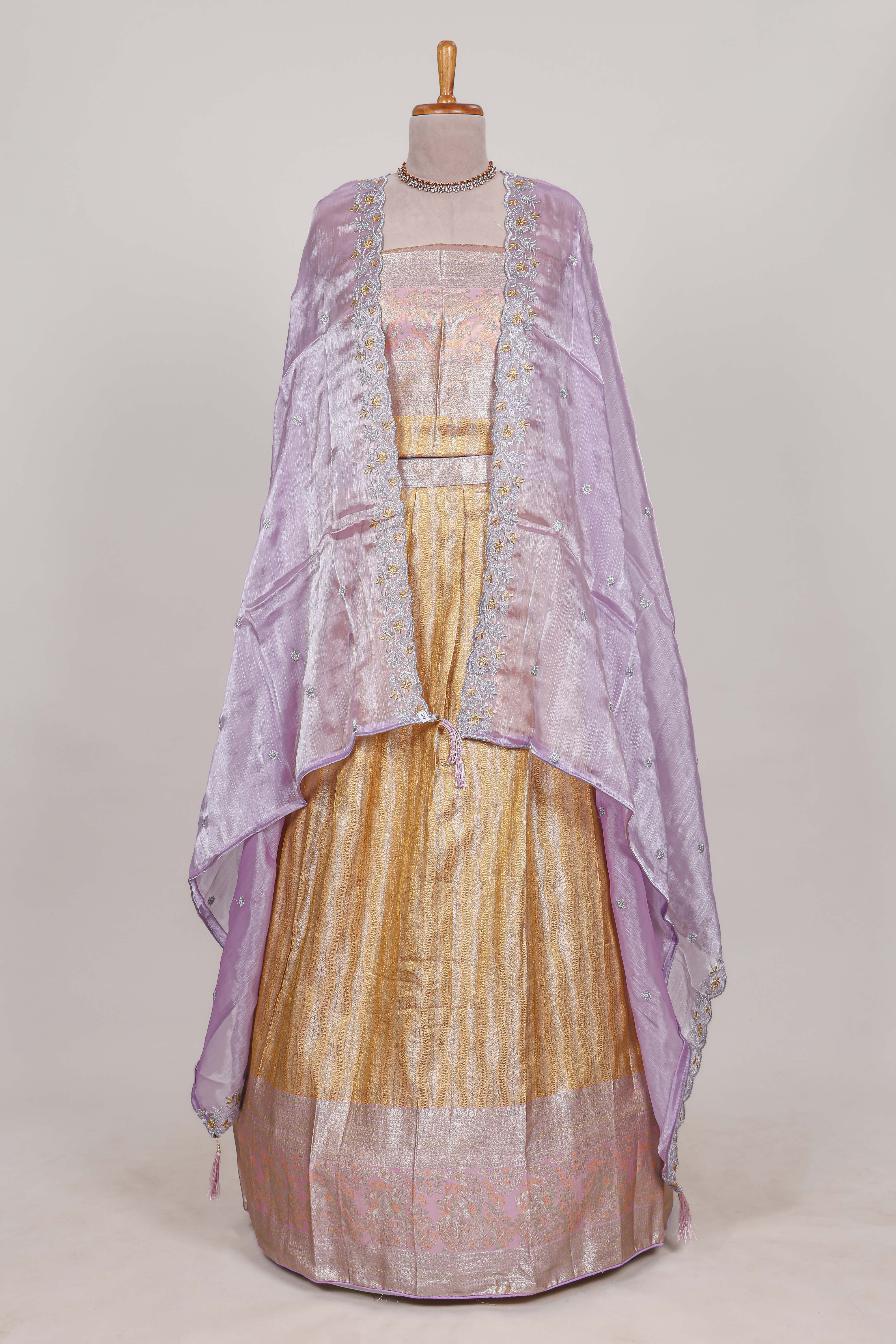Cream tissue lehenga featuring elegant vertical line patterns with a beautiful contrast border Paired with a matching shawl