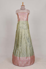 Pastel green tissue lehenga featuring elegant vertical line patterns with a beautiful contrast border Paired with a matching shawl