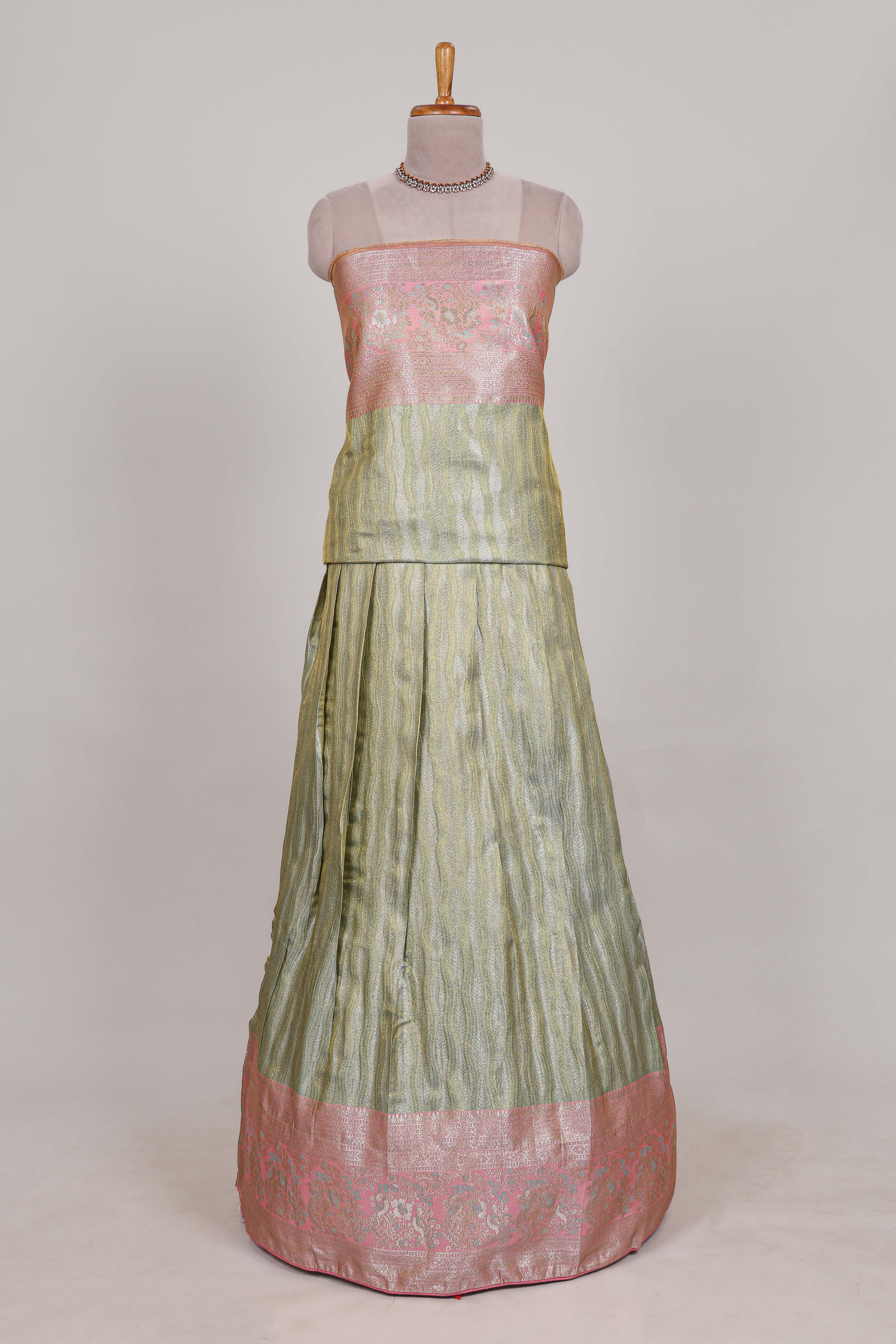 Pastel green tissue lehenga featuring elegant vertical line patterns with a beautiful contrast border Paired with a matching shawl