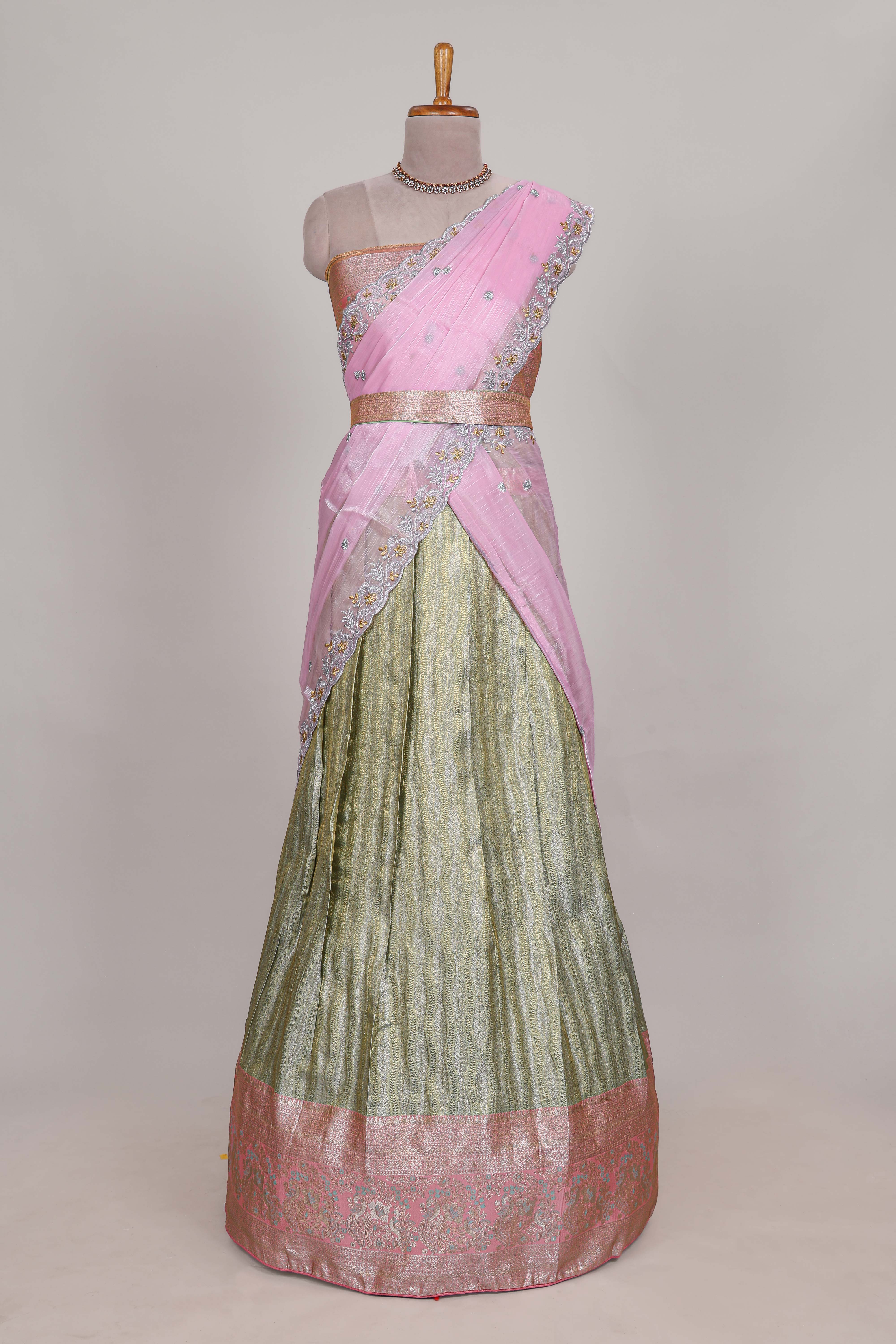 Pastel green tissue lehenga featuring elegant vertical line patterns with a beautiful contrast border Paired with a matching shawl