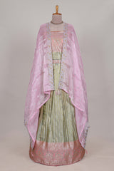 Pastel green tissue lehenga featuring elegant vertical line patterns with a beautiful contrast border Paired with a matching shawl
