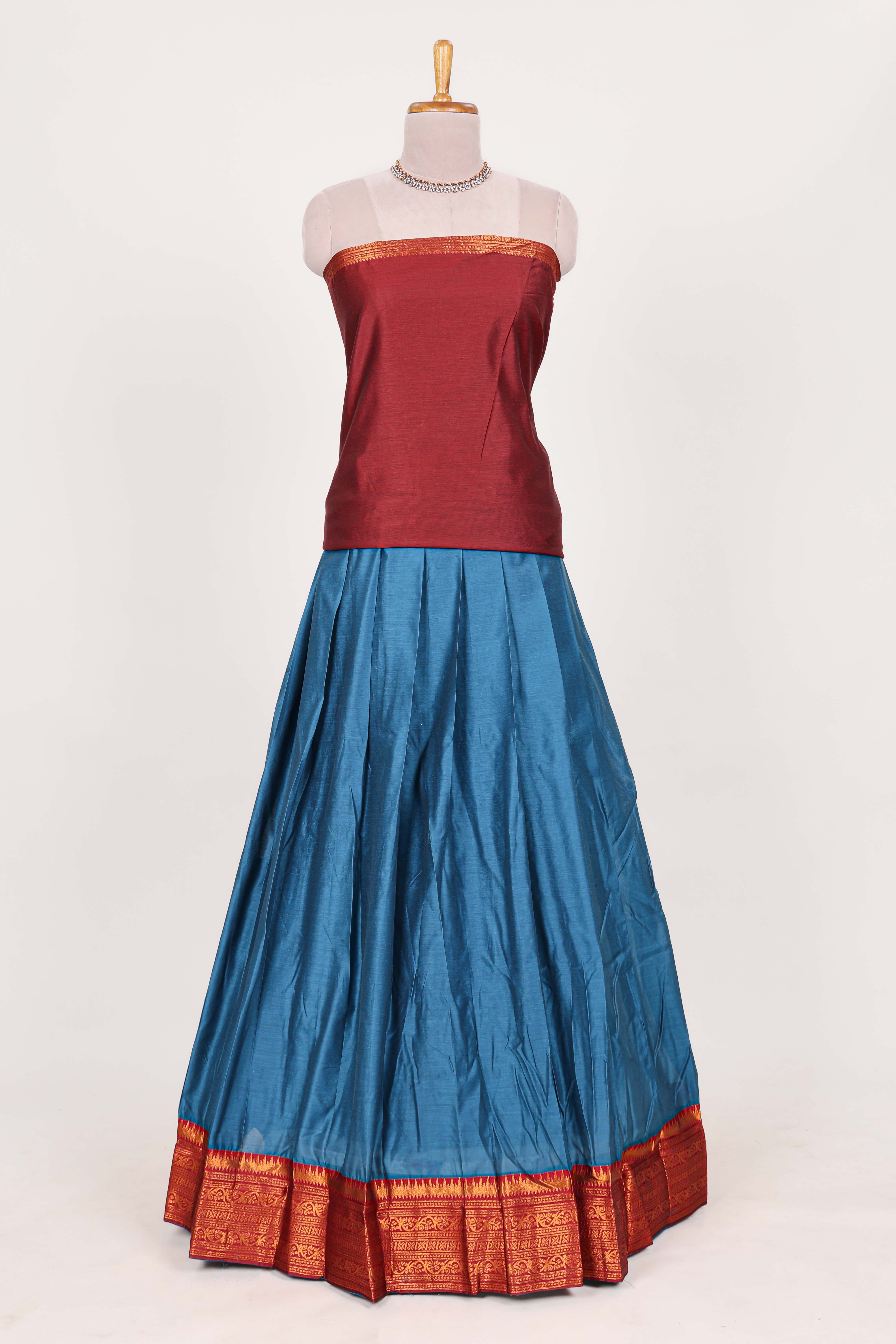 Royal bluesilk cotton lehenga with a rich maroon shawl with a traditional silver zari woven border and contrast blouse