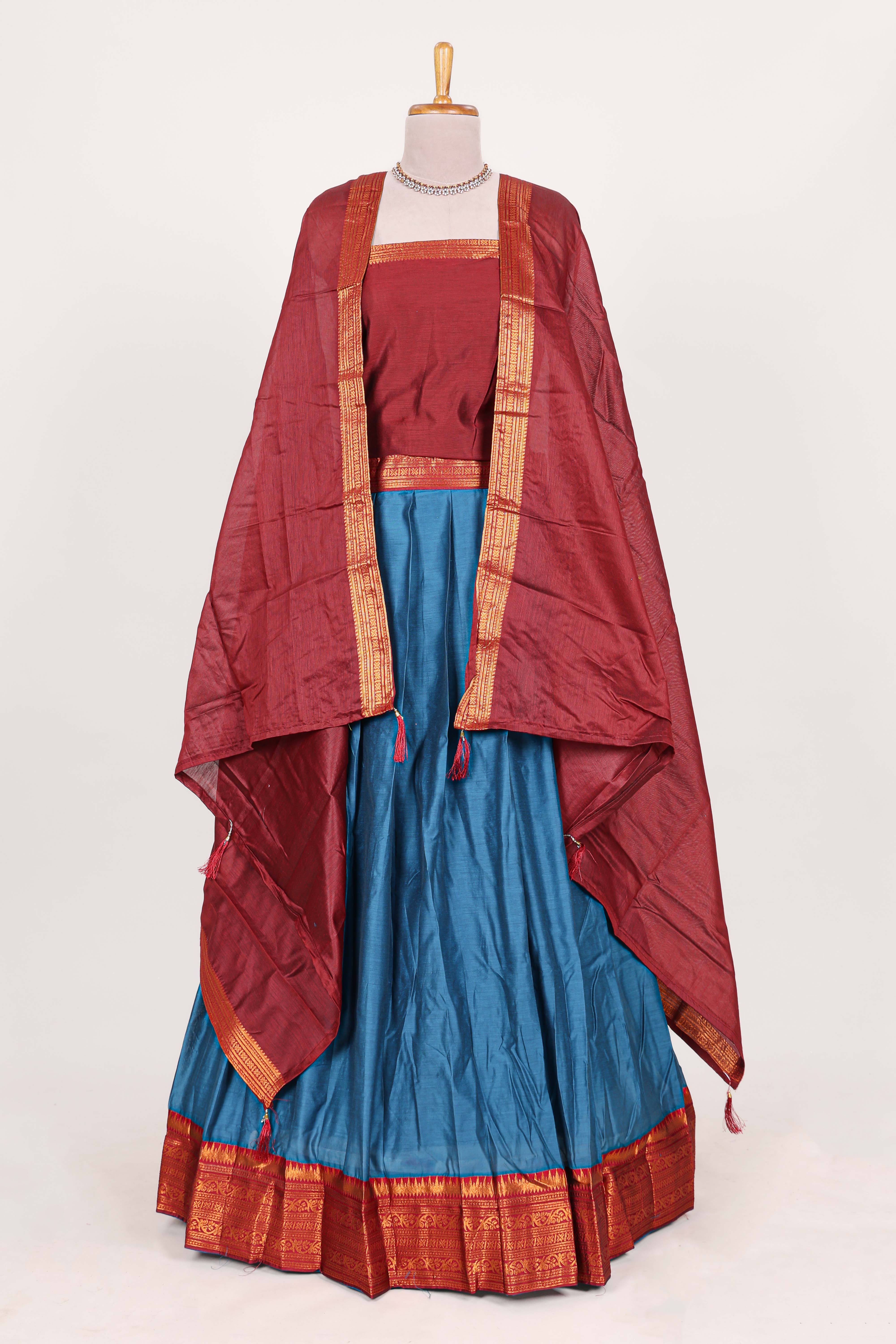 Royal bluesilk cotton lehenga with a rich maroon shawl with a traditional silver zari woven border and contrast blouse