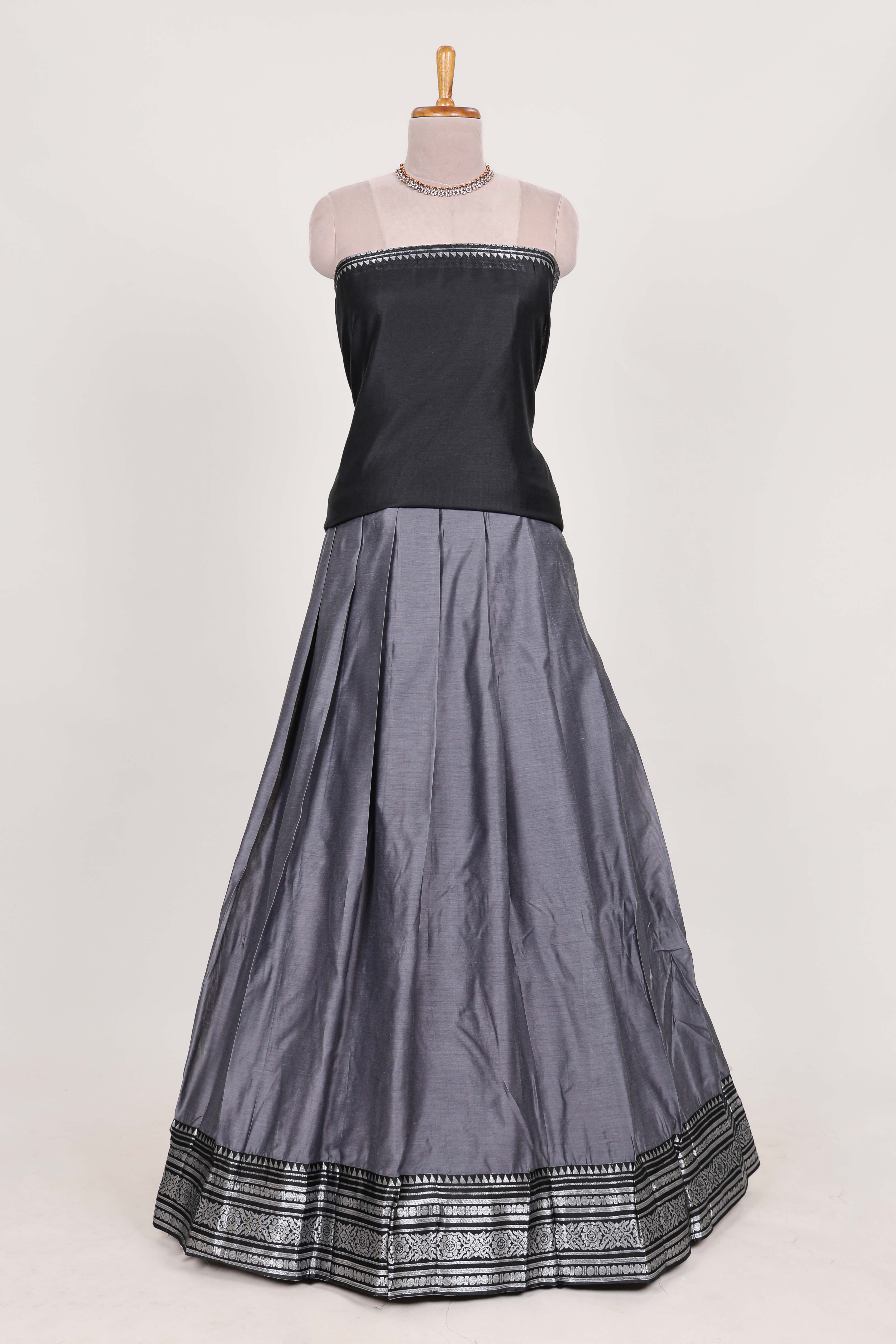 Grey silk cotton lehenga with a black shawl with a traditional silver zari woven border and contrast blouse