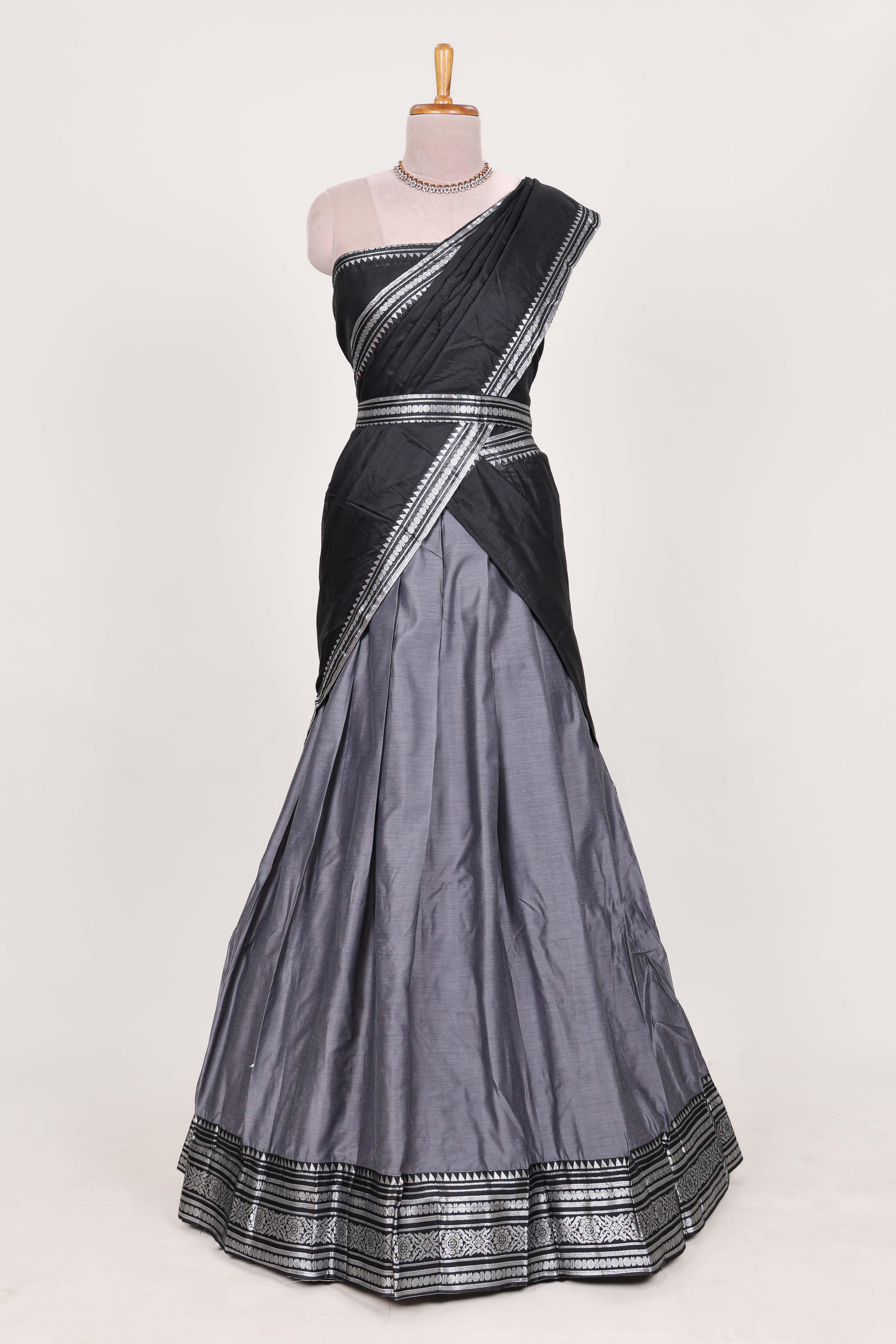 Grey silk cotton lehenga with a black shawl with a traditional silver zari woven border and contrast blouse