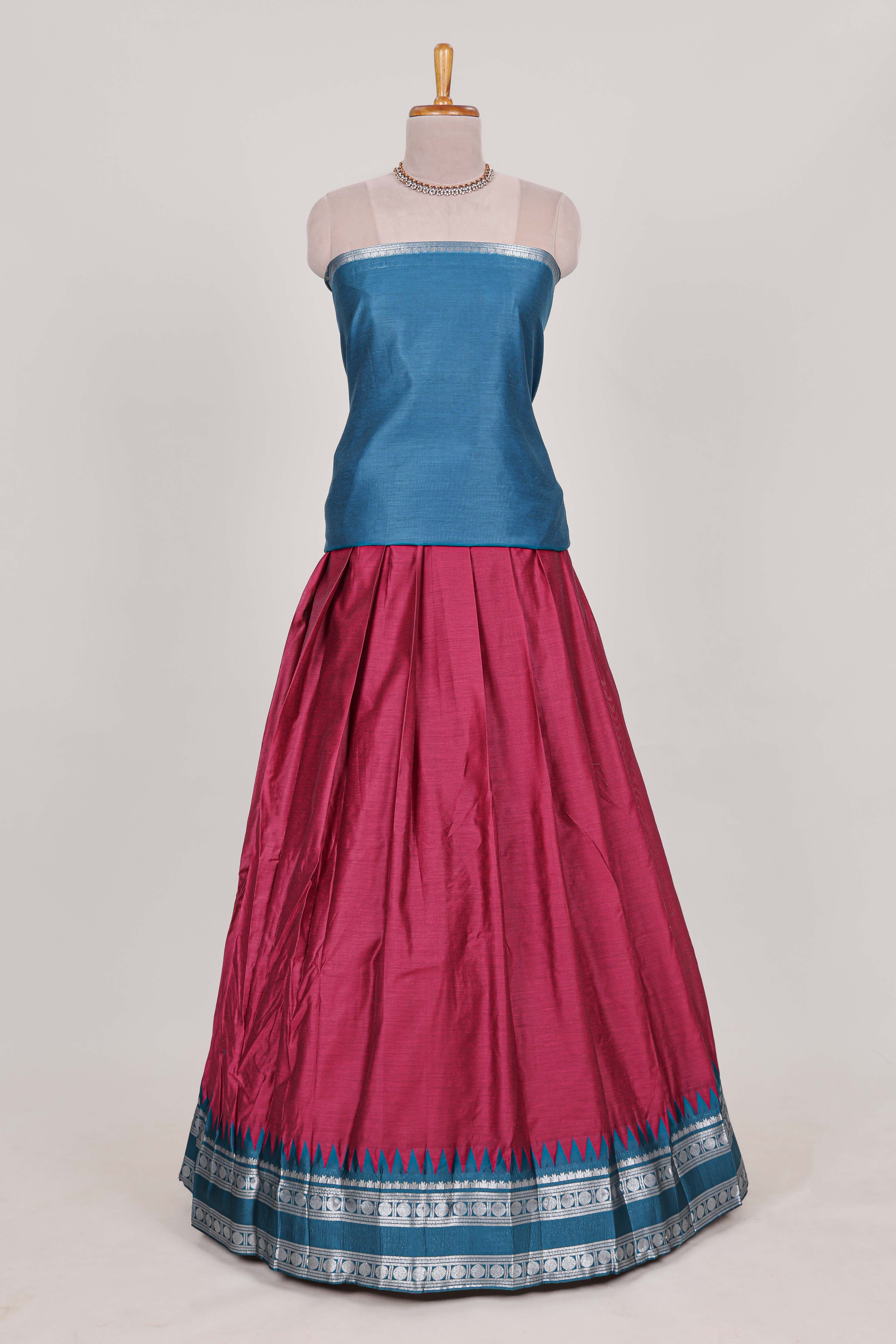 Rani pink silk cotton lehenga with a black shawl with a traditional silver zari woven border and contrast blouse