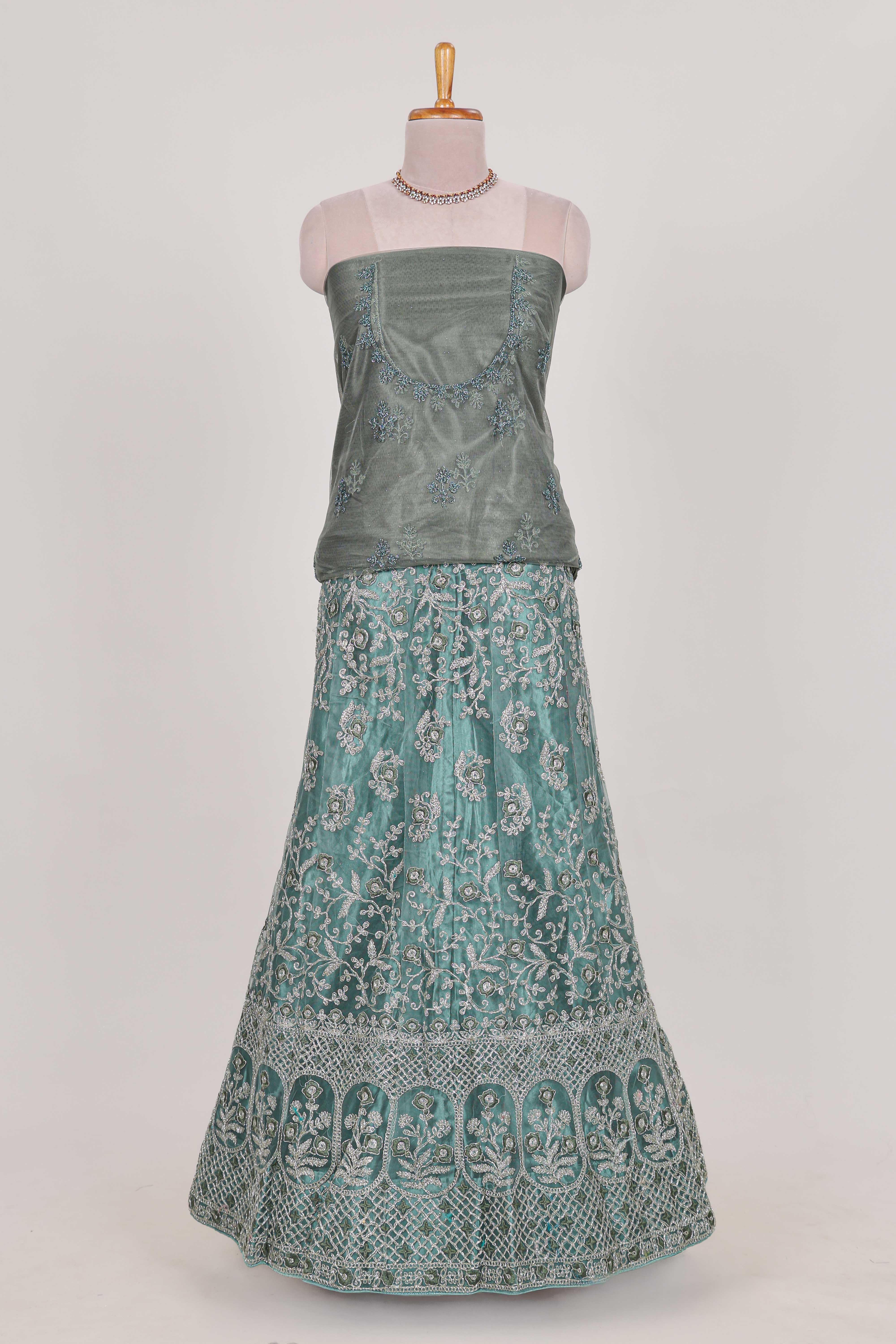 Pastel Sage Green Beautiful net lehenga with intricate embroidery stone work and contrast border paired with a contrast net shawl