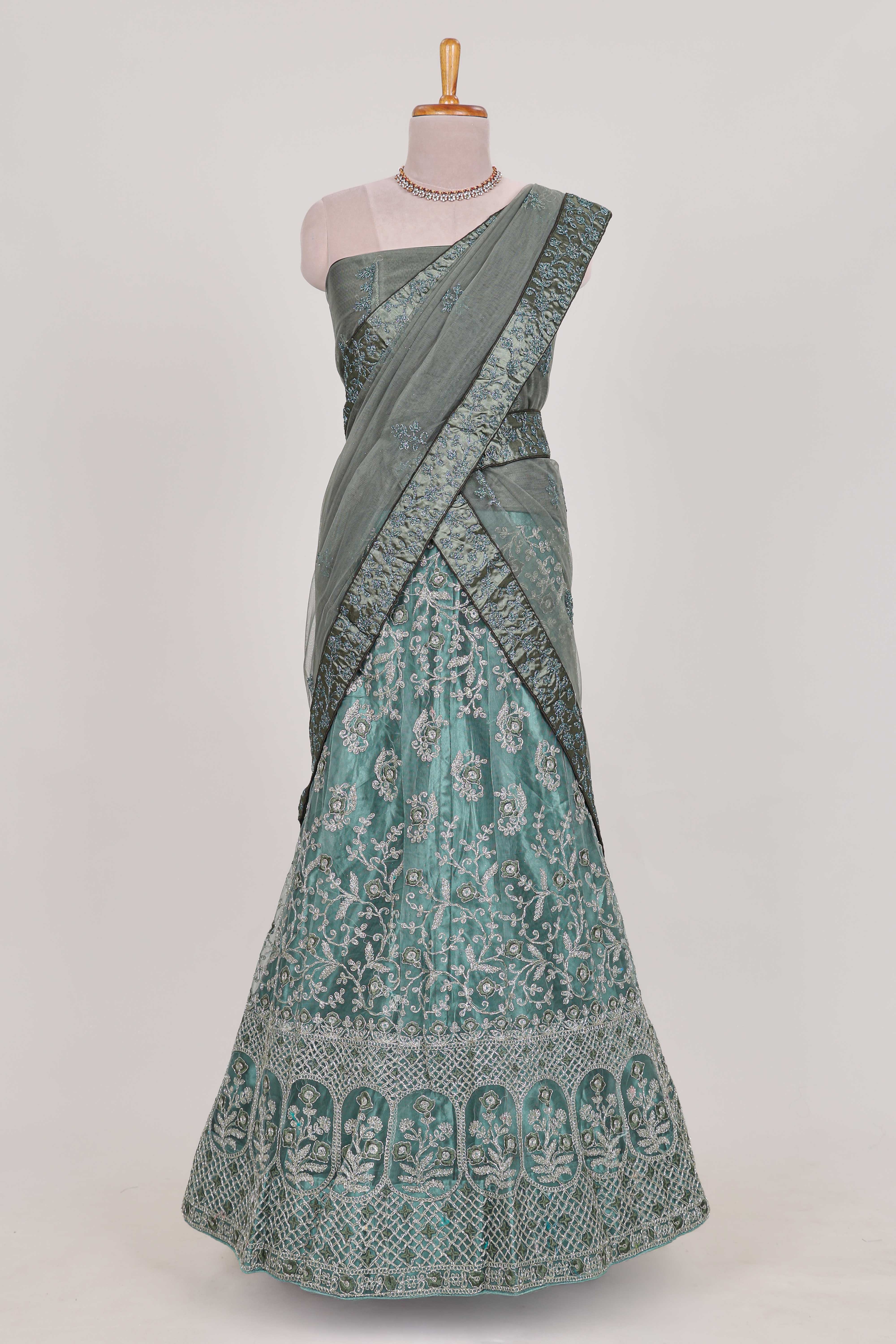 Pastel Sage Green Beautiful net lehenga with intricate embroidery stone work and contrast border paired with a contrast net shawl