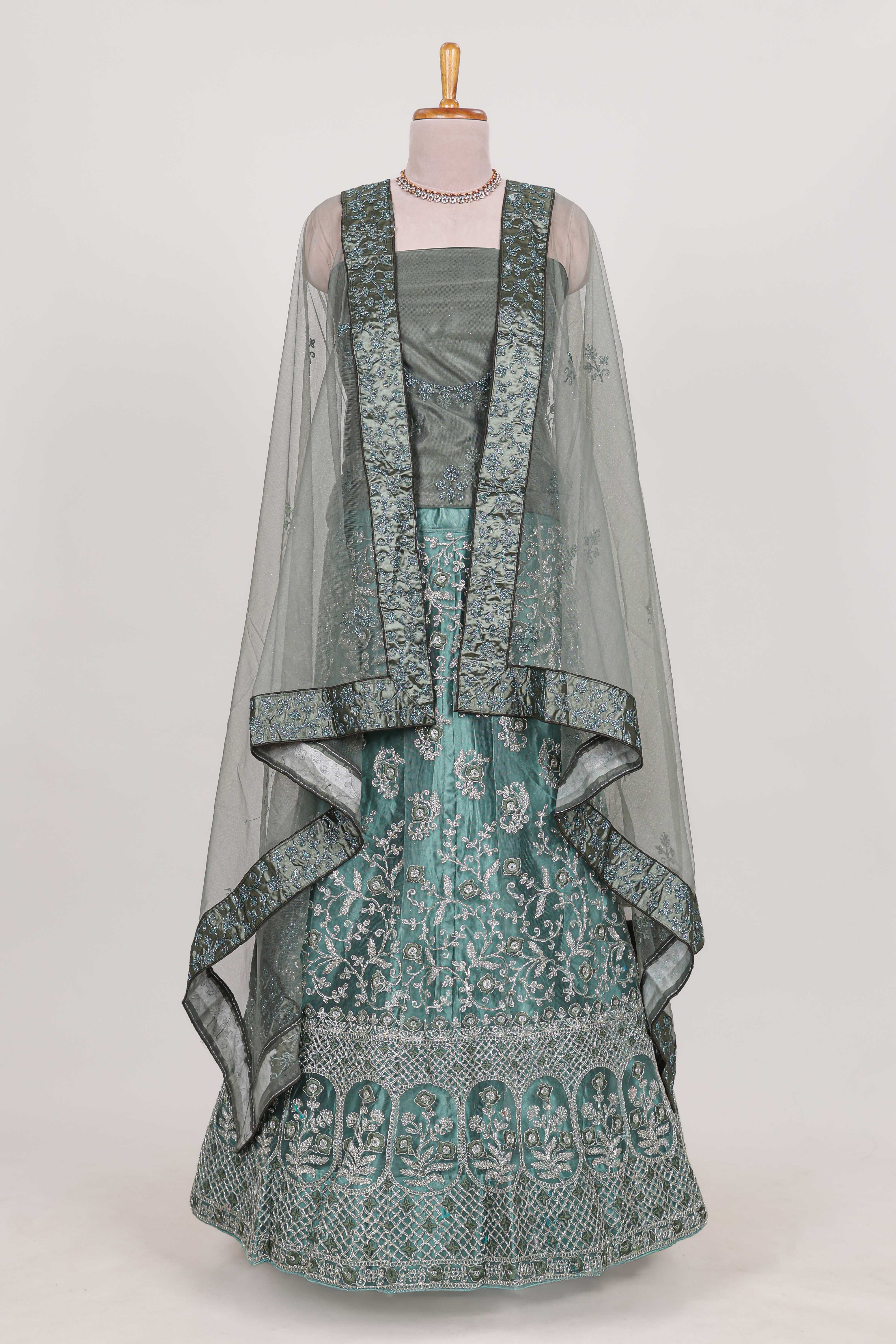 Pastel Sage Green Beautiful net lehenga with intricate embroidery stone work and contrast border paired with a contrast net shawl