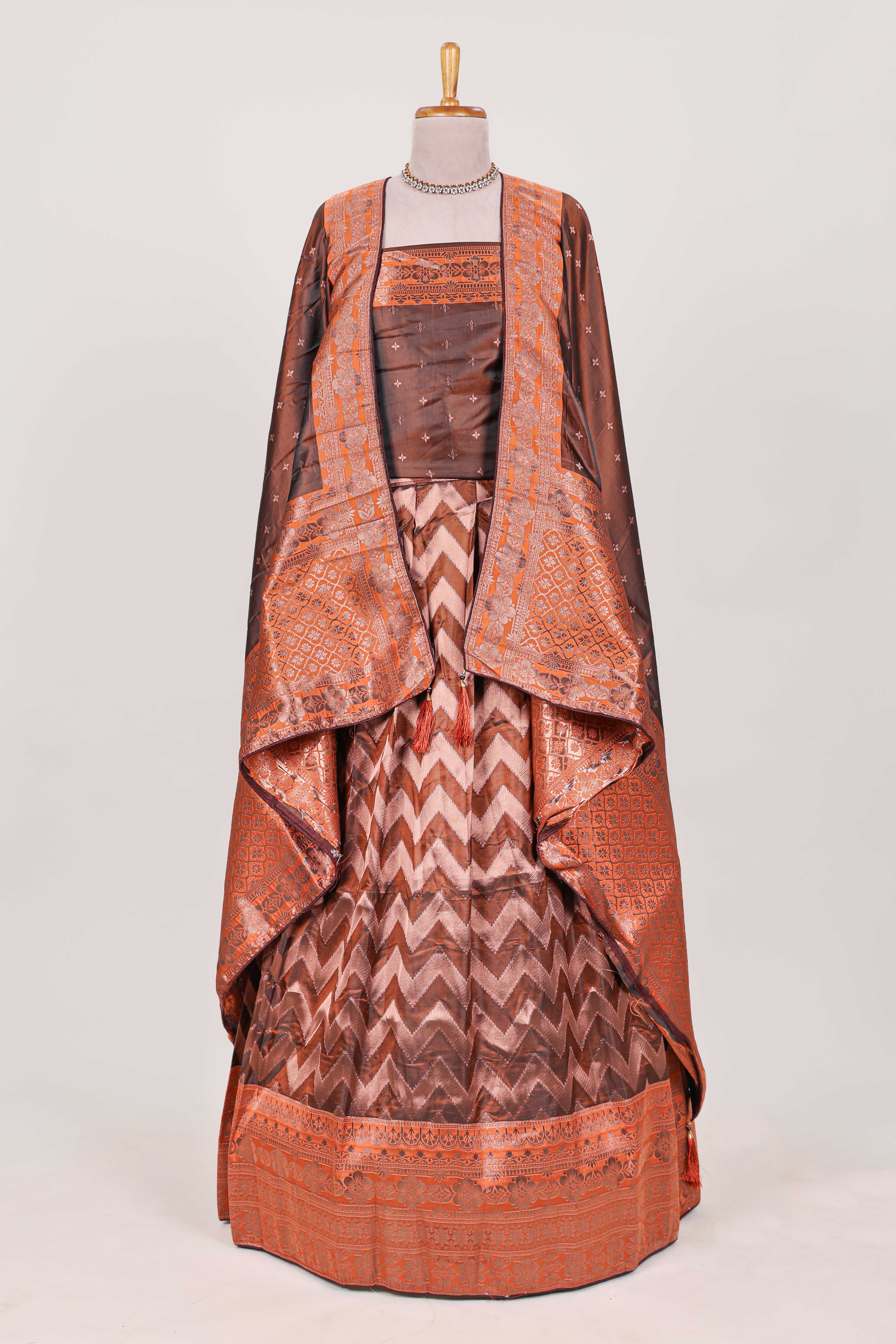 Brown lehenga featuring intricate copper thread weaving details with a beautiful contrast border Paired with a brocadeshawl