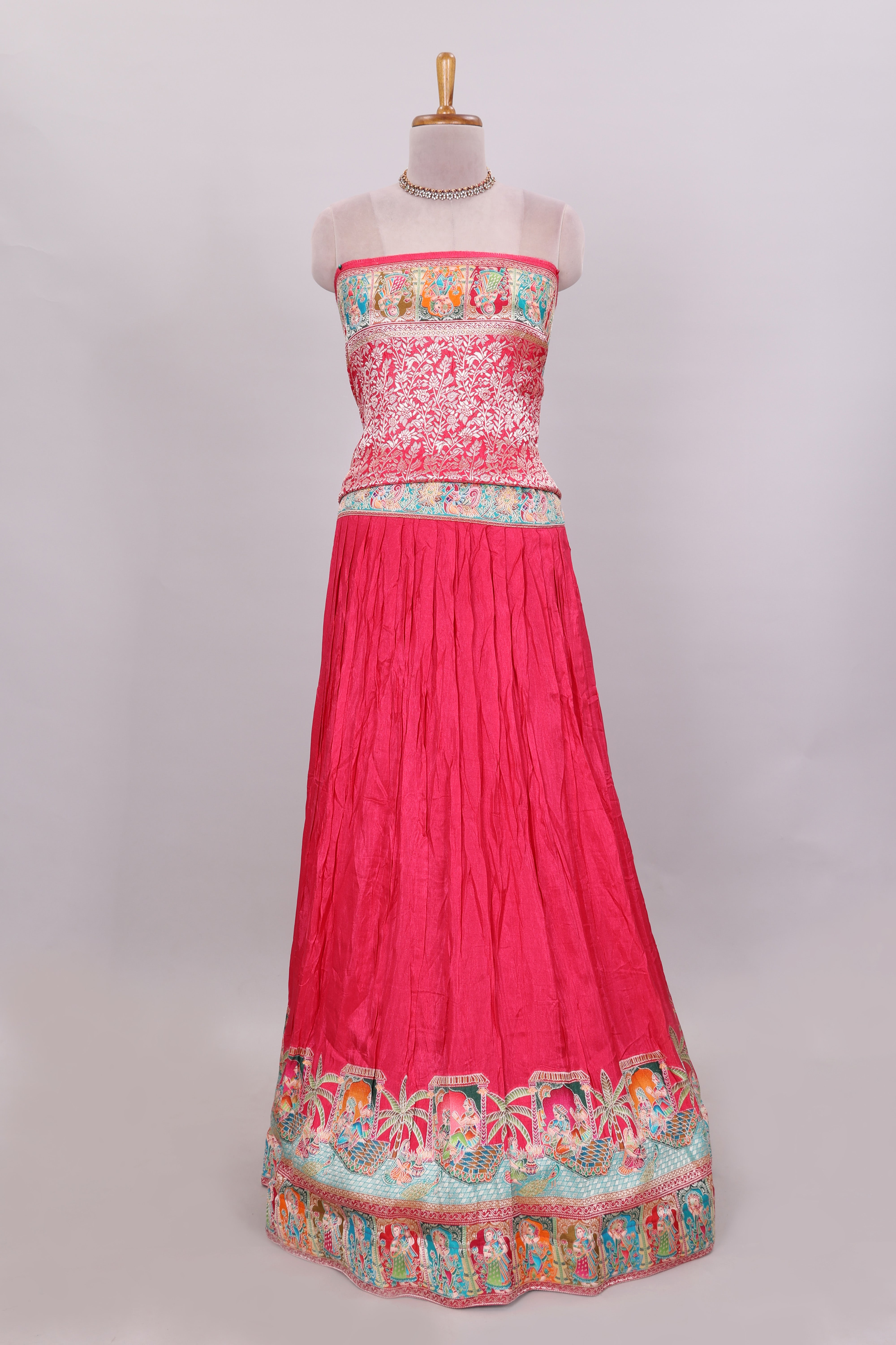 Rani pink plain lehenga featuring with human figure motifs with floral and ornamental detailing border Paired with a teal blue floral designedshawl