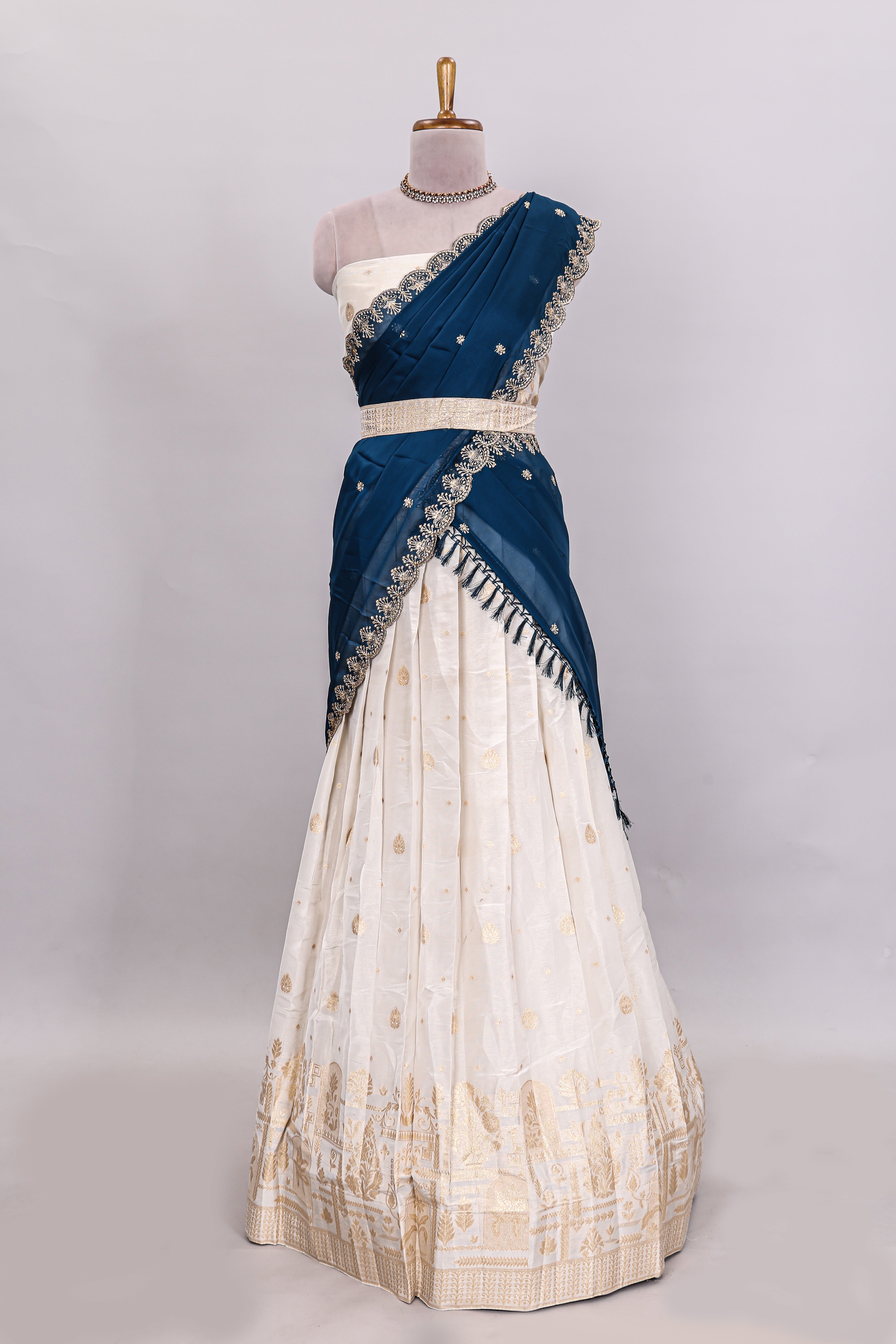 Ivory floral butta motif deigns lehenga featuring self golden zari border and matching blouse Paired with navy blue Floral butta shawl