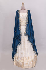 Ivory floral butta motif deigns lehenga featuring self golden zari border and matching blouse Paired with navy blue Floral butta shawl