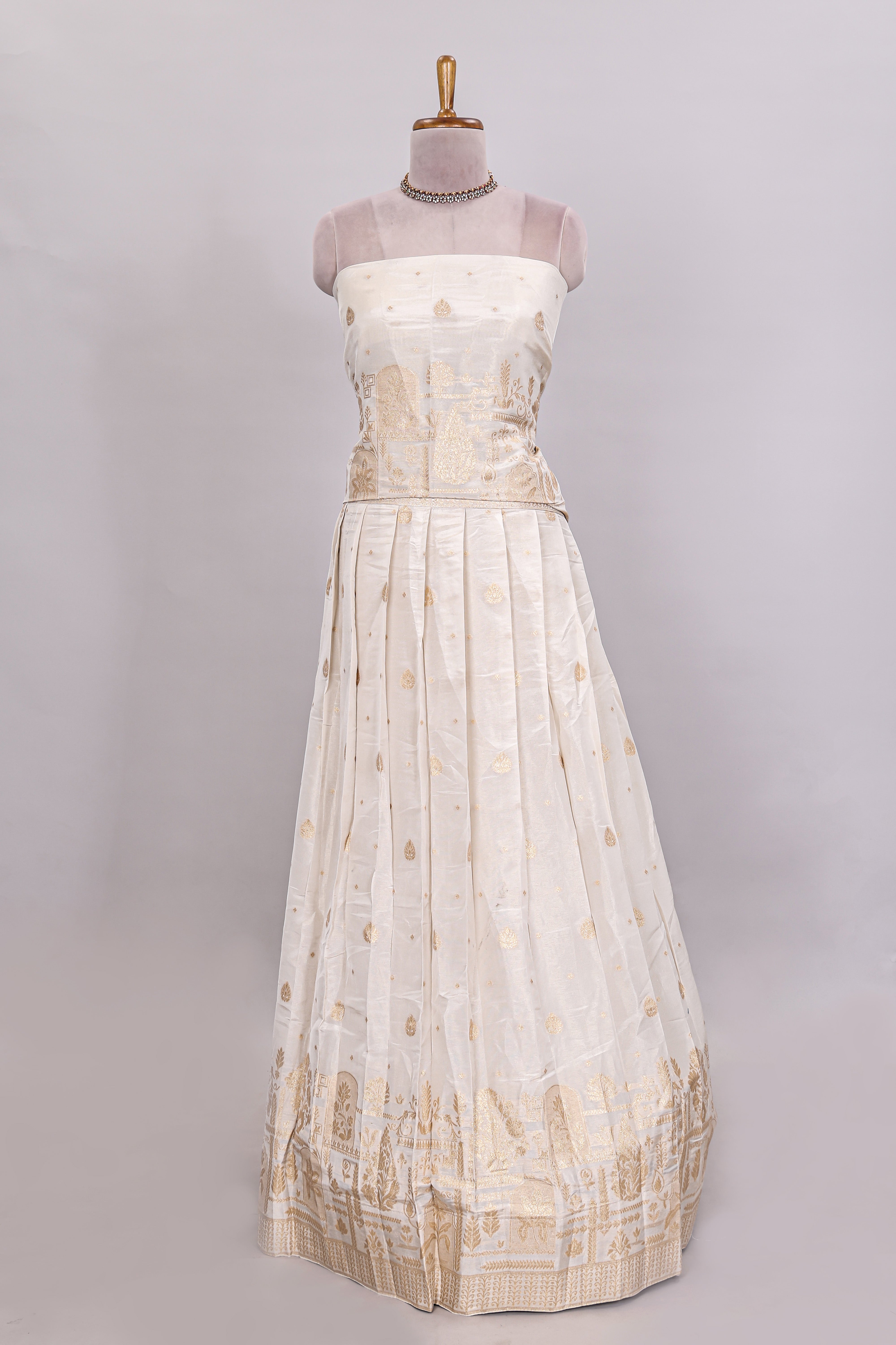 Ivory floral butta motif deigns lehenga featuring self golden zari border and matching blouse Paired with navy blue Floral butta shawl