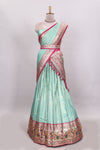 Pista green butta designed lehanga with contrast floral design border and contrast blouse paired with matching floral butta motifs shawl