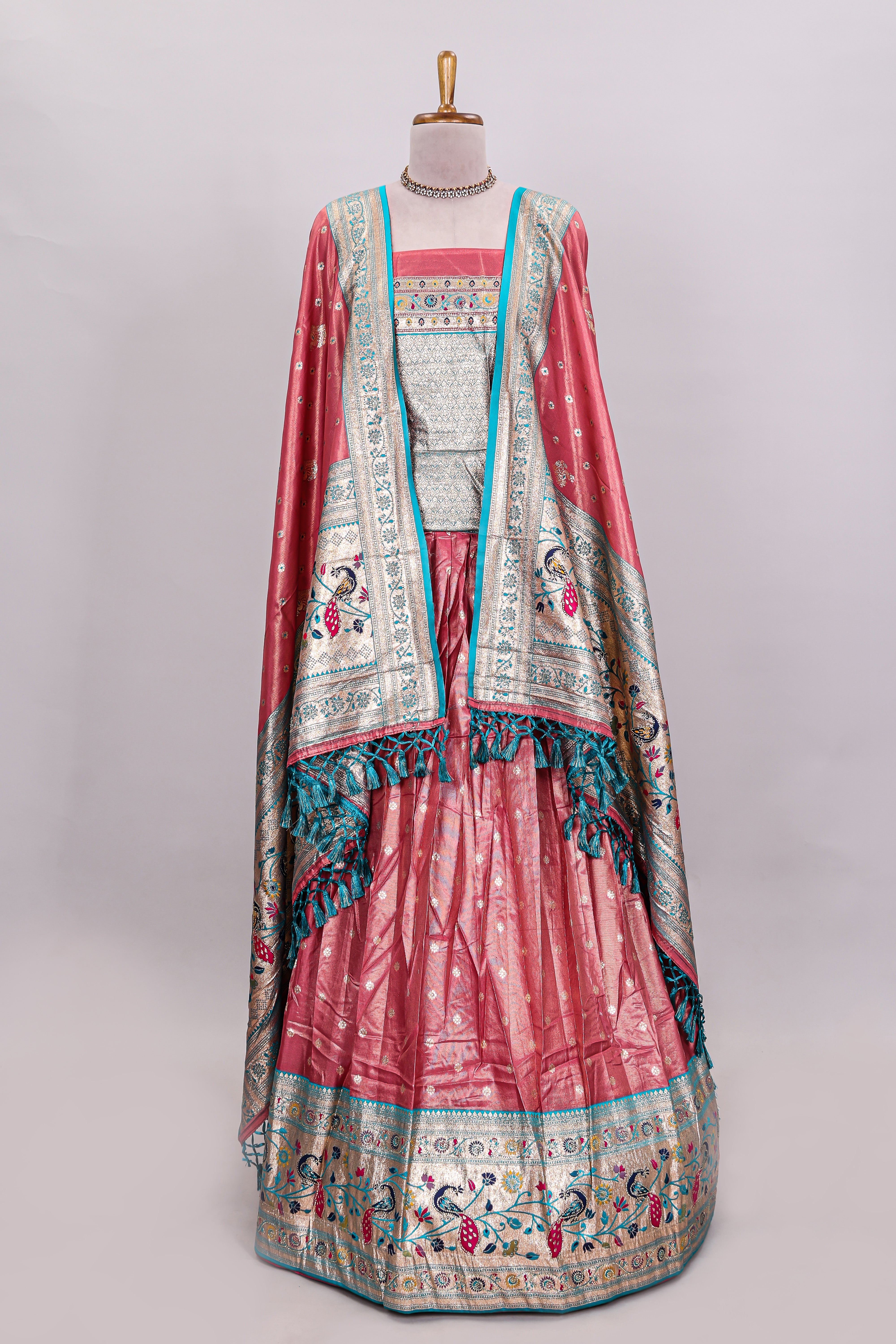 Peach butta designed lehanga with contrast floral design border and contrast blouse paired with matching floral butta motifs shawl
