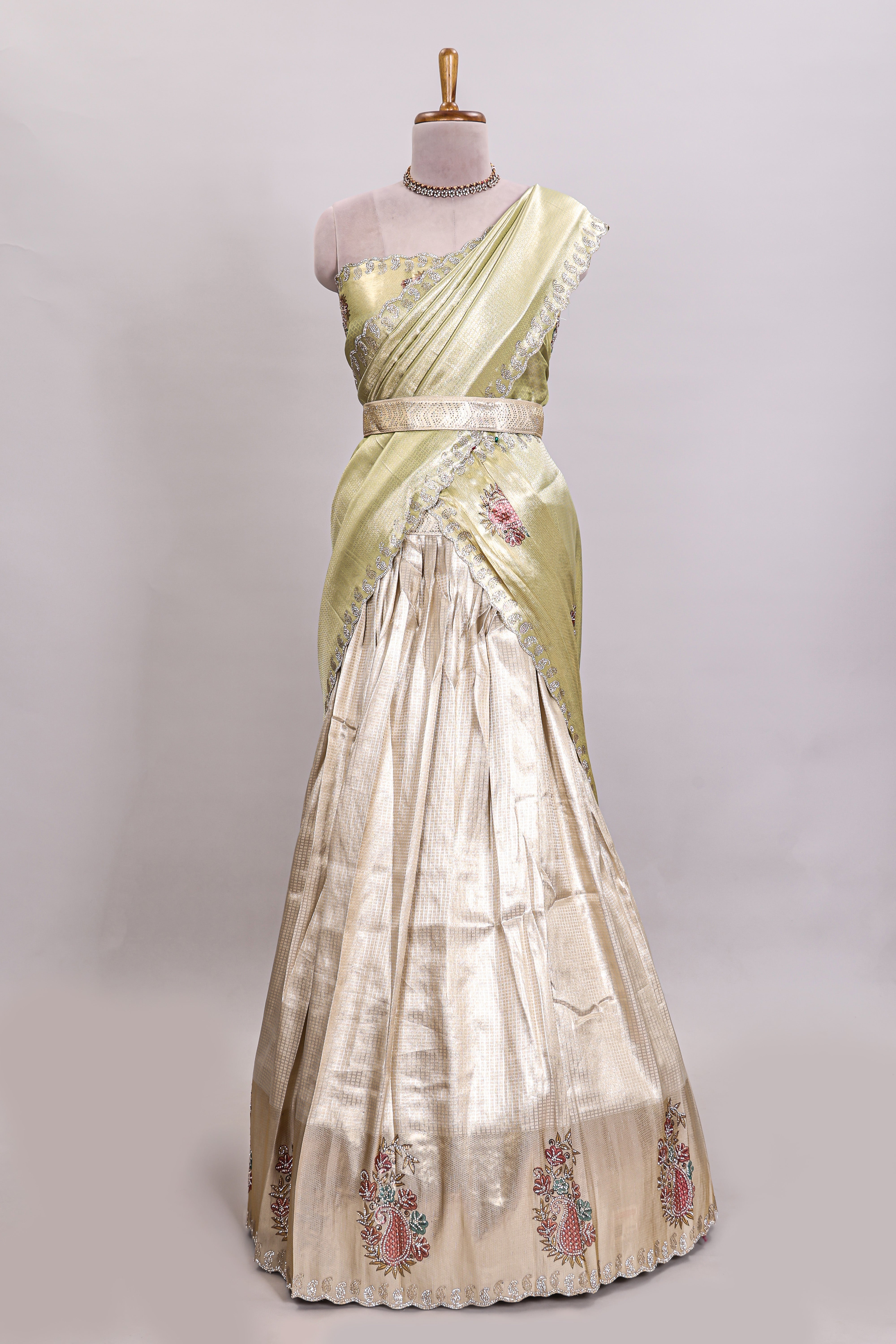 Gold shade lehanga with self manga motif border and light green shade contrast blouse paired with plain shawl with floral motifs