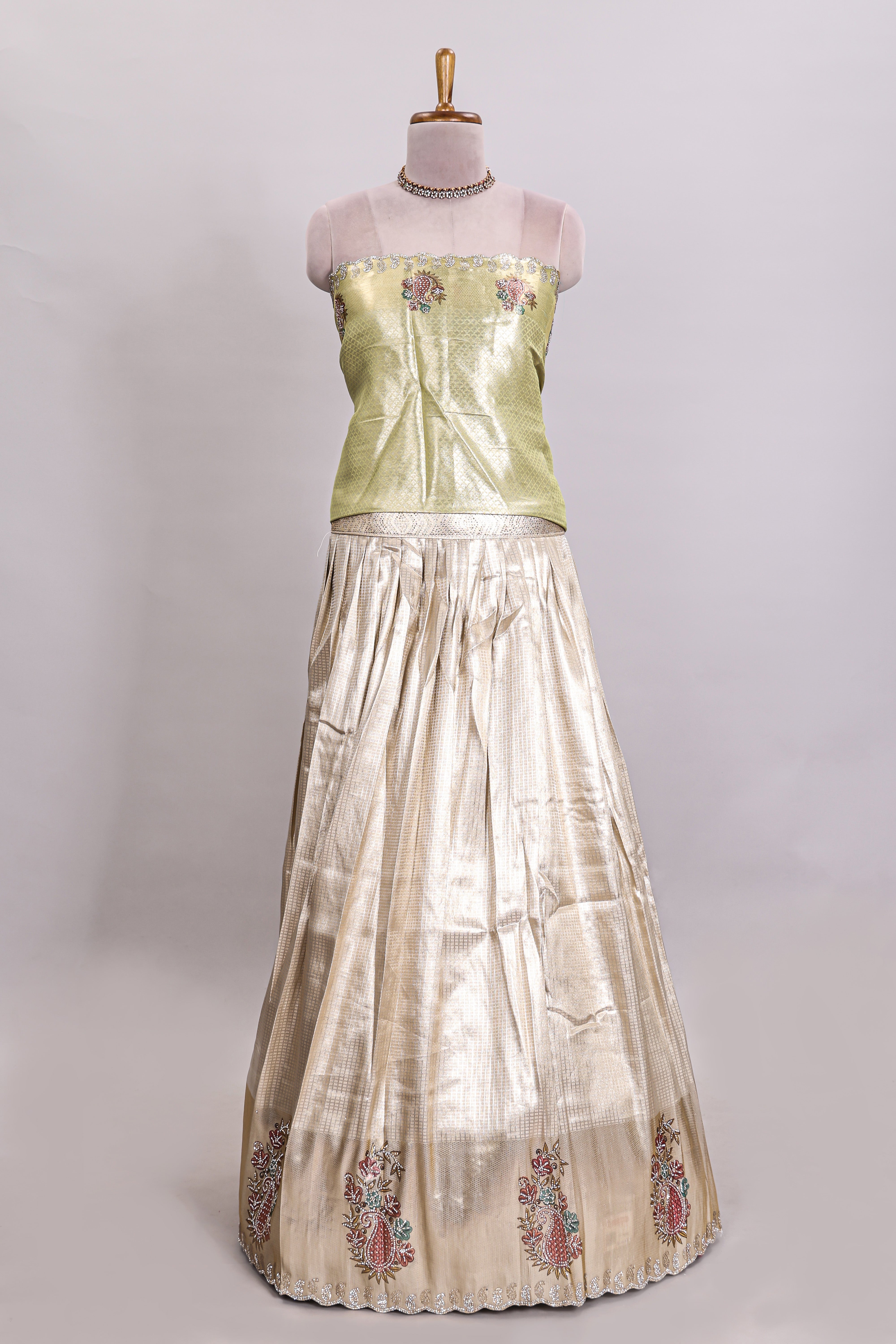 Gold shade lehanga with self manga motif border and light green shade contrast blouse paired with plain shawl with floral motifs