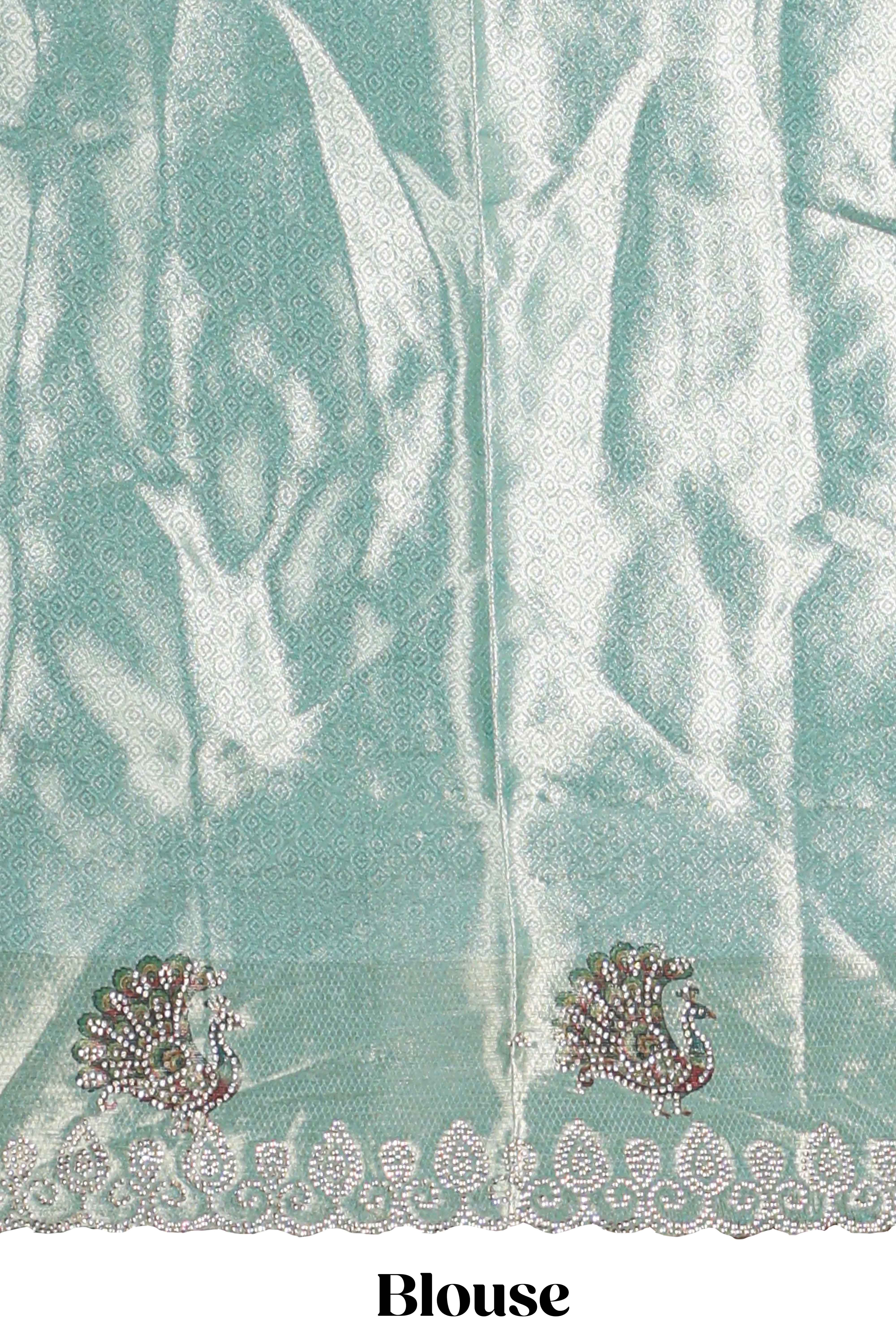 Off white tissue lehenga featuring intricate woven floral paisley motifs with a beautiful zari border Paired with a seafoam green shawl