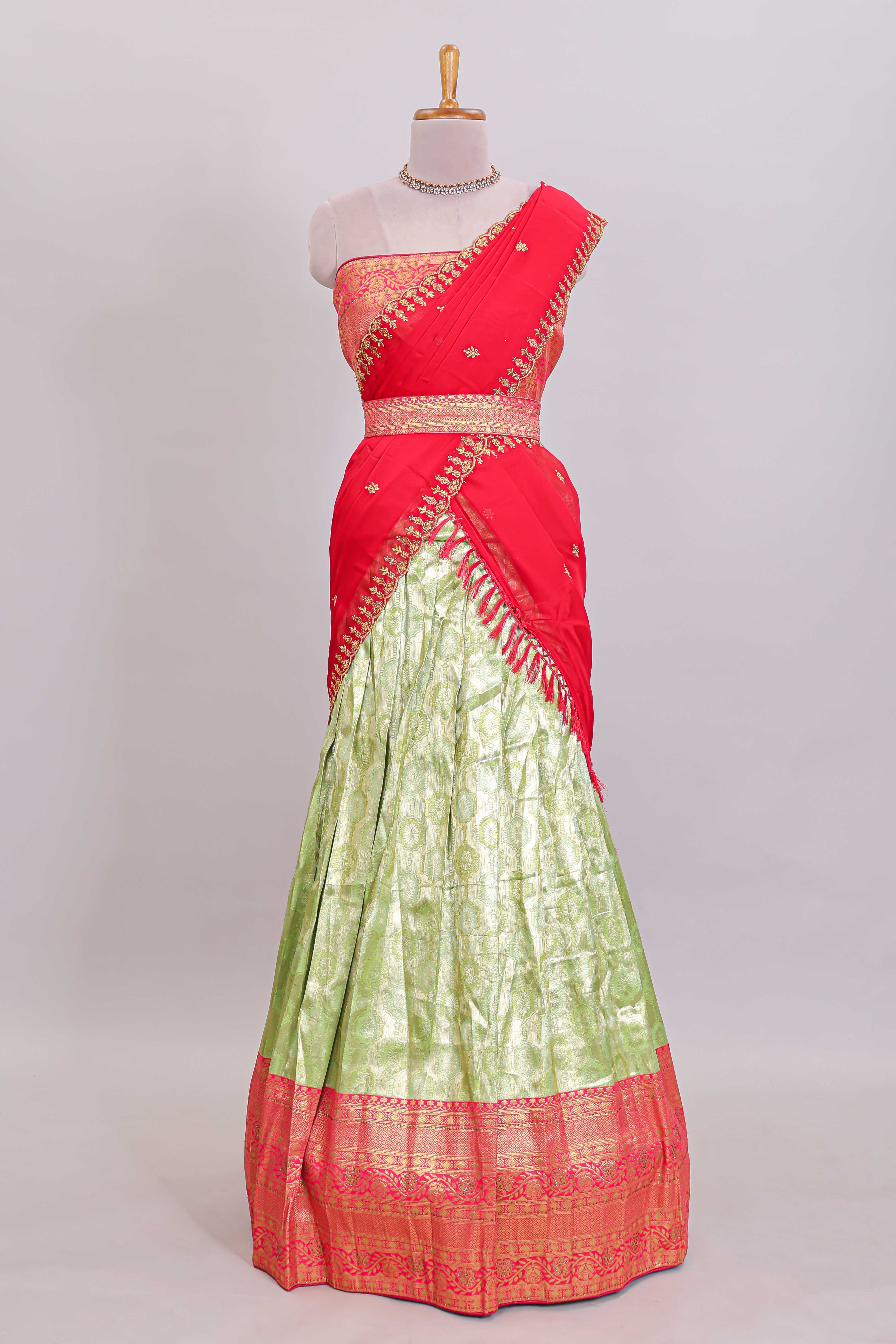 Pastel green Manga Butta motifs lehanga featuring contrasting border and matching blouse paired with contrast red shawl