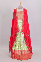 Pastel green Manga Butta motifs lehanga featuring contrasting border and matching blouse paired with contrast red shawl