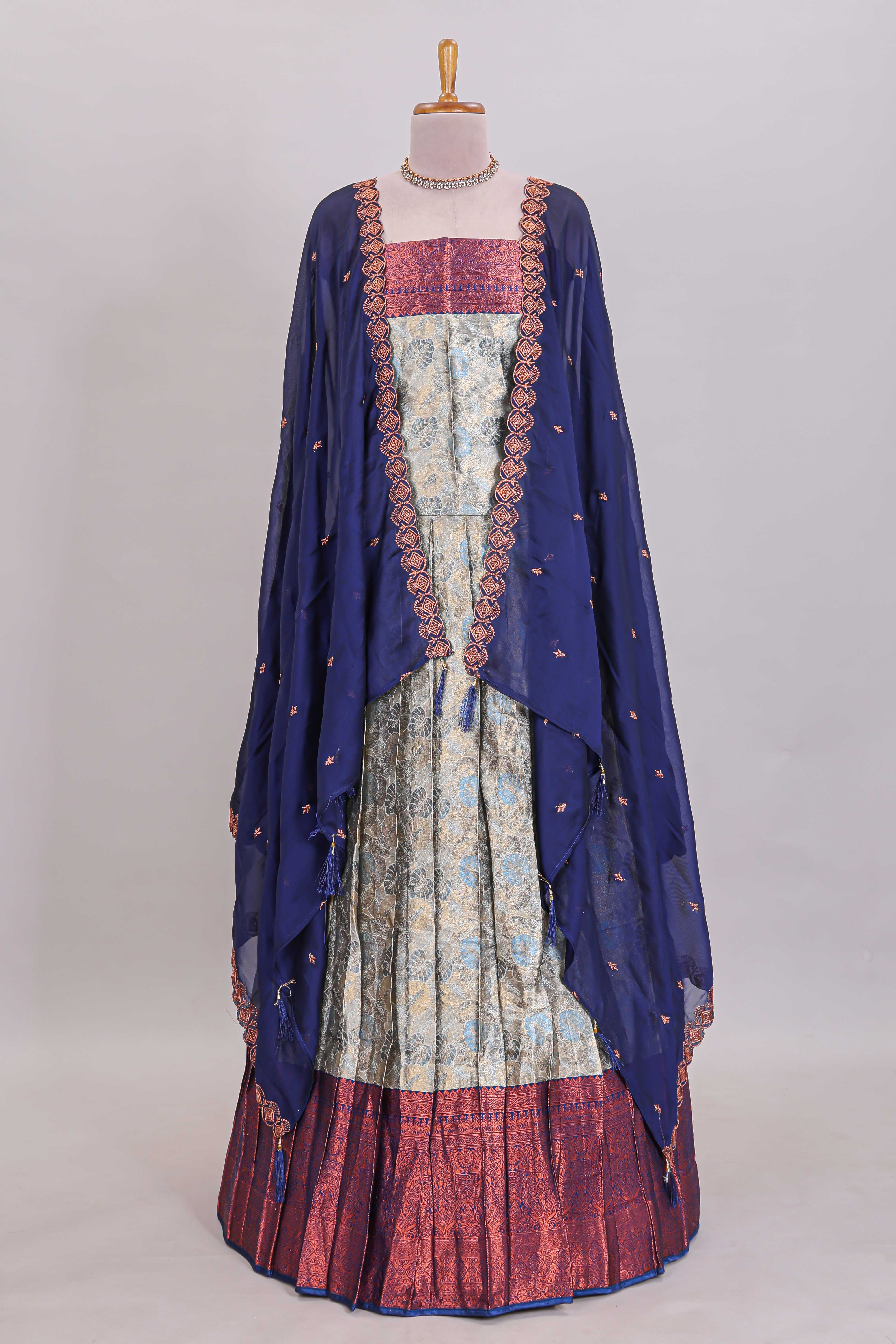 Antique ivory unique designed lehanga featuring contrasting border and matching blouse paired with contrast navy blue shawl