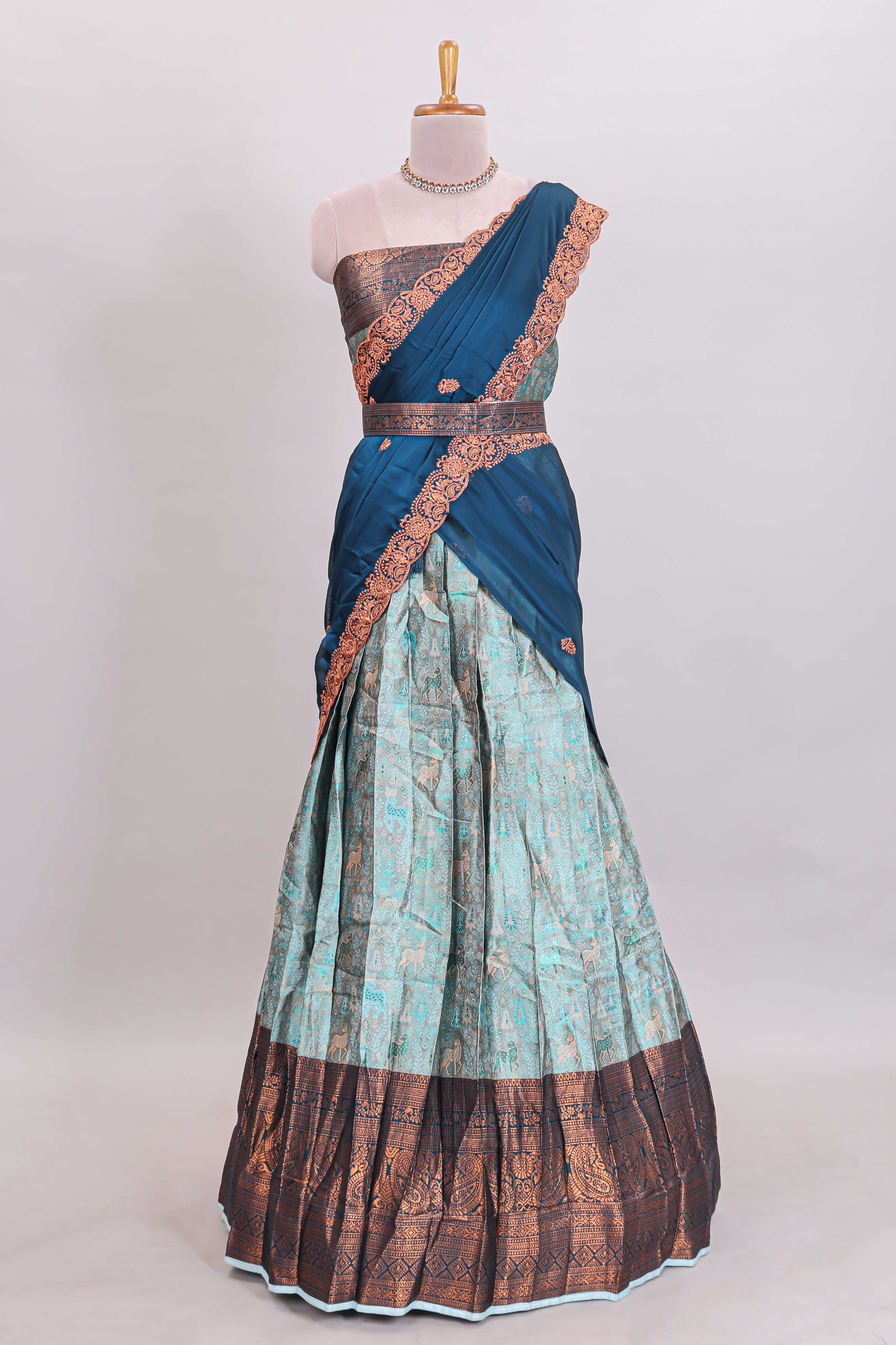 Light aqua blue floral and deer motifs lehanga featuring contrasting geometric zari border and matching blouse paired with contrast blue shawl