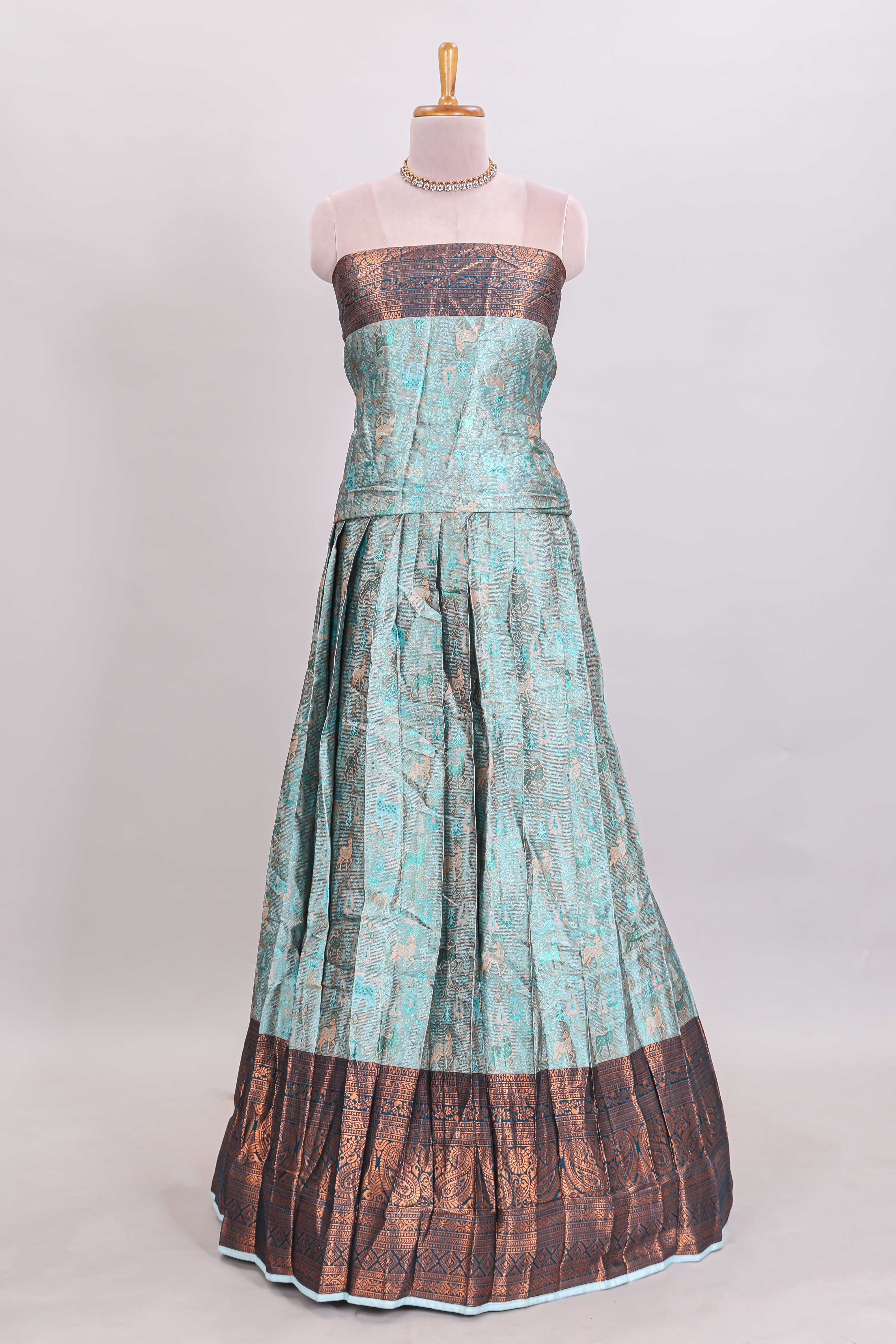 Light aqua blue floral and deer motifs lehanga featuring contrasting geometric zari border and matching blouse paired with contrast blue shawl