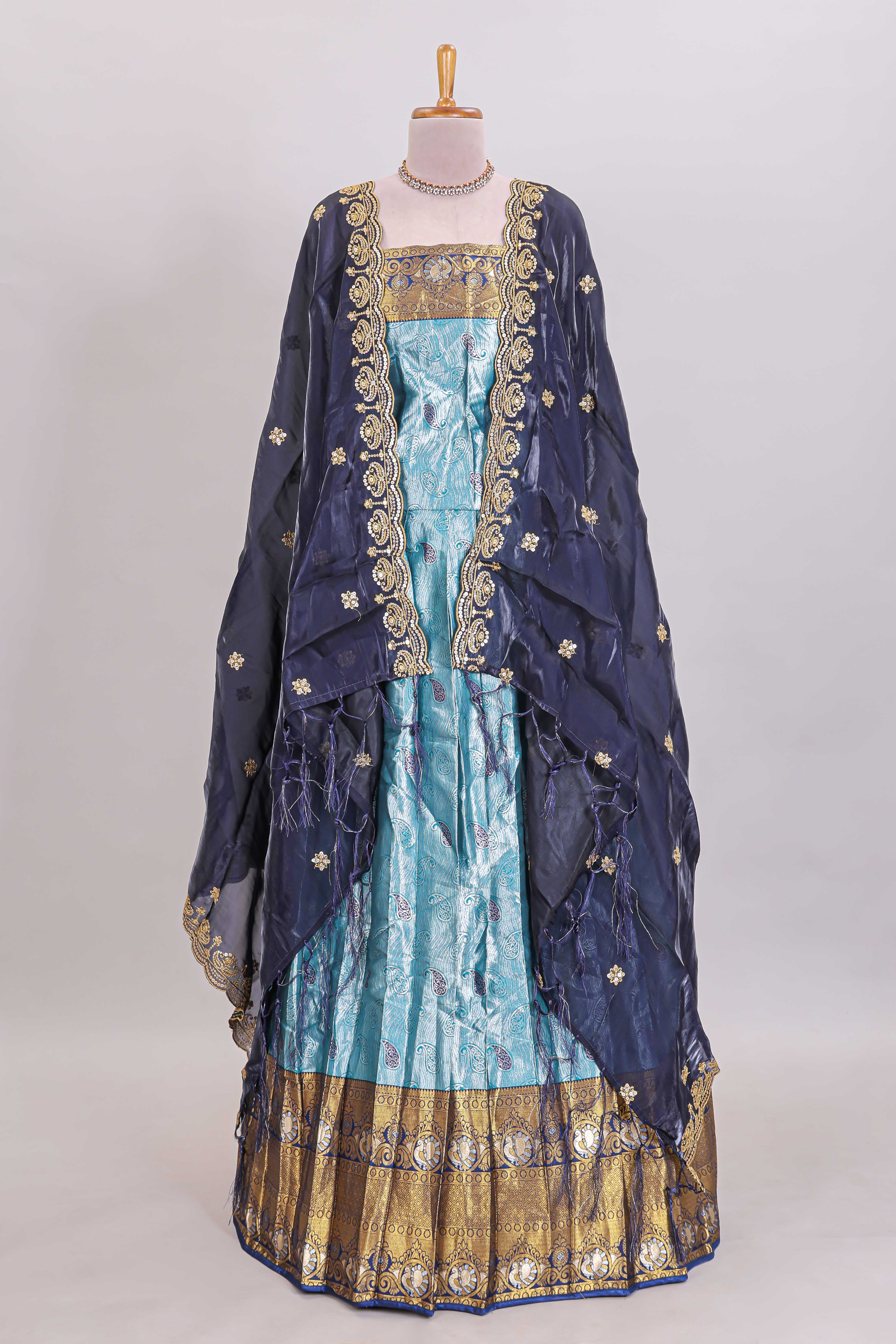 Light blue shade manga motifs lehanga featuring contrasting zari border and matching blouse paired withnavy blue organza shawl