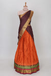 Orange shade plain lehanga featuring contrasting zari border and blouse paired with brown shawl