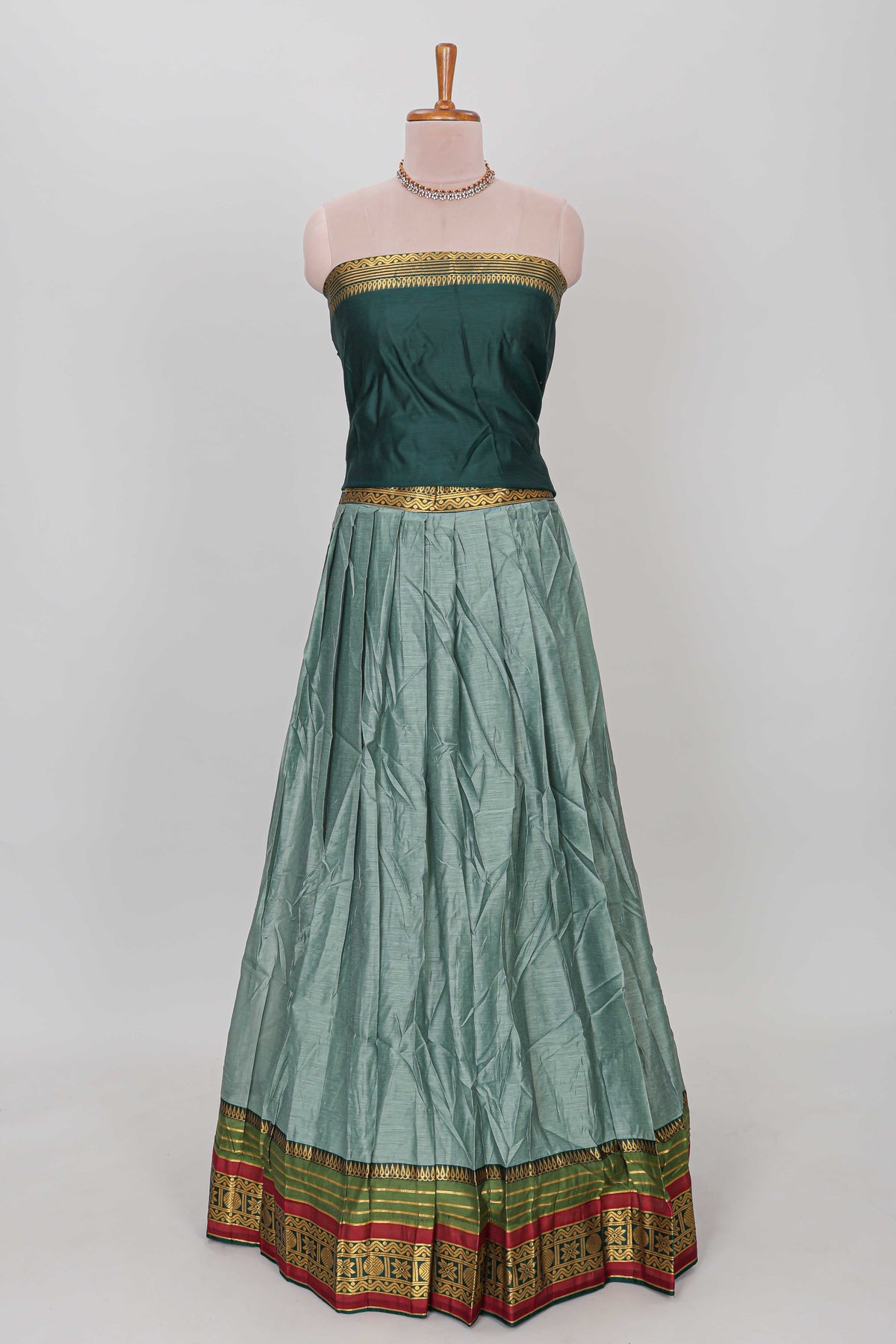 Green shade plain lehanga featuring contrasting zari border and blouse paired with pine green shawl