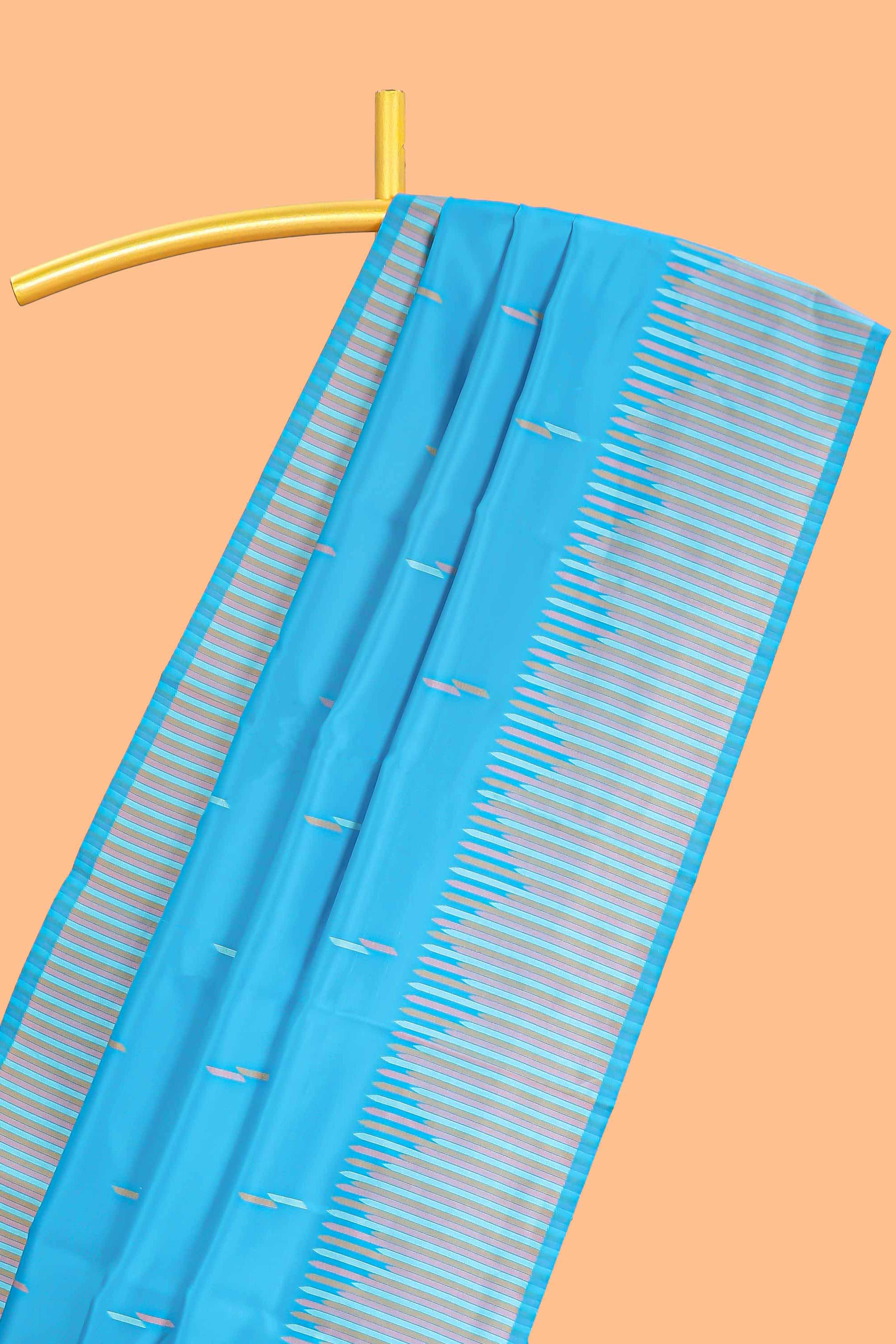 Blue geometric style motifs litchi silk saree with contrast striped border and blouse
