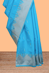 Blue geometric style motifs litchi silk saree with contrast striped border and blouse