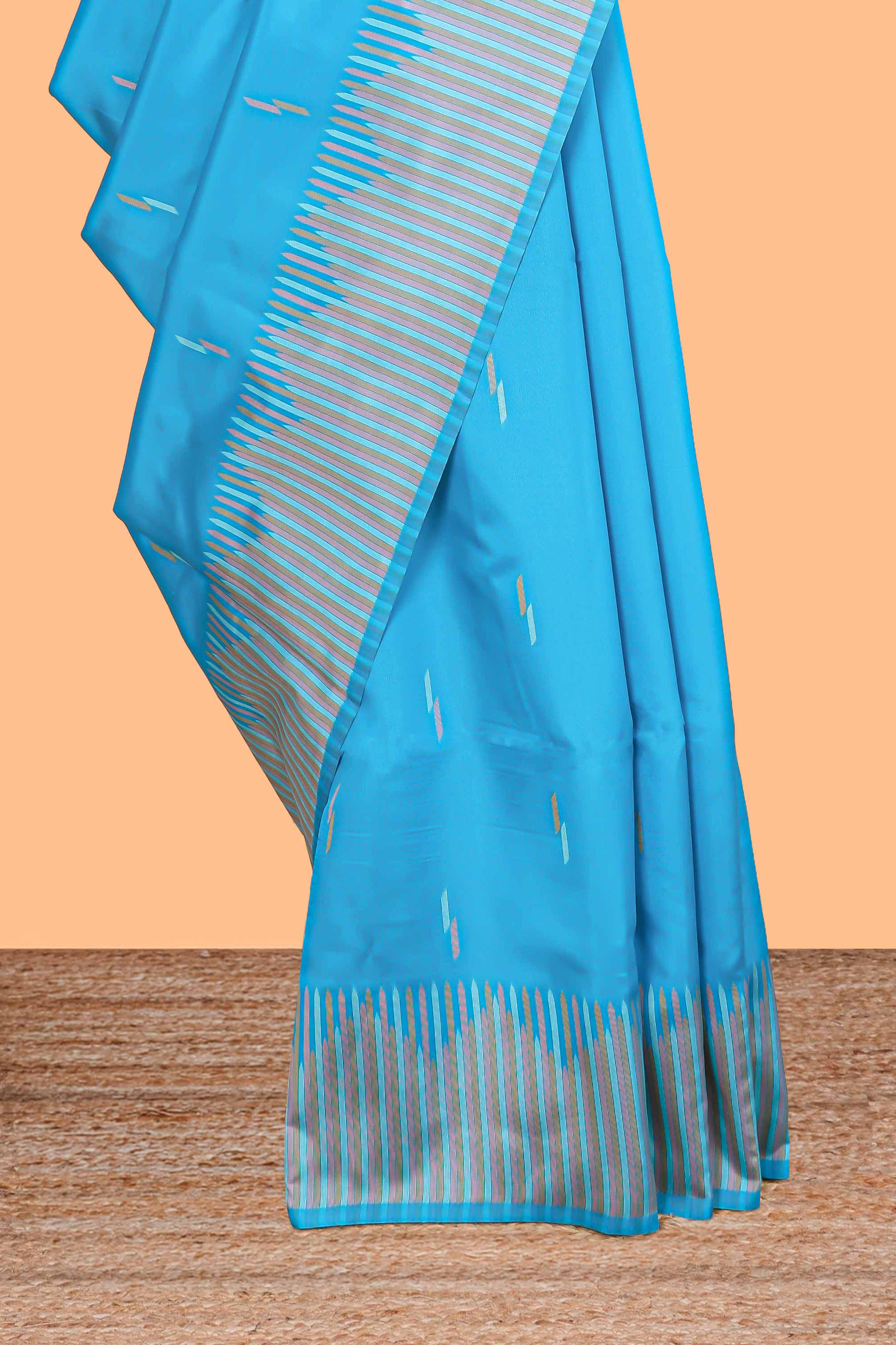 Blue geometric style motifs litchi silk saree with contrast striped border and blouse