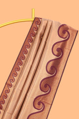 Beige chevron zari design litchi silk saree with contrast swirl shape zari border and blouse