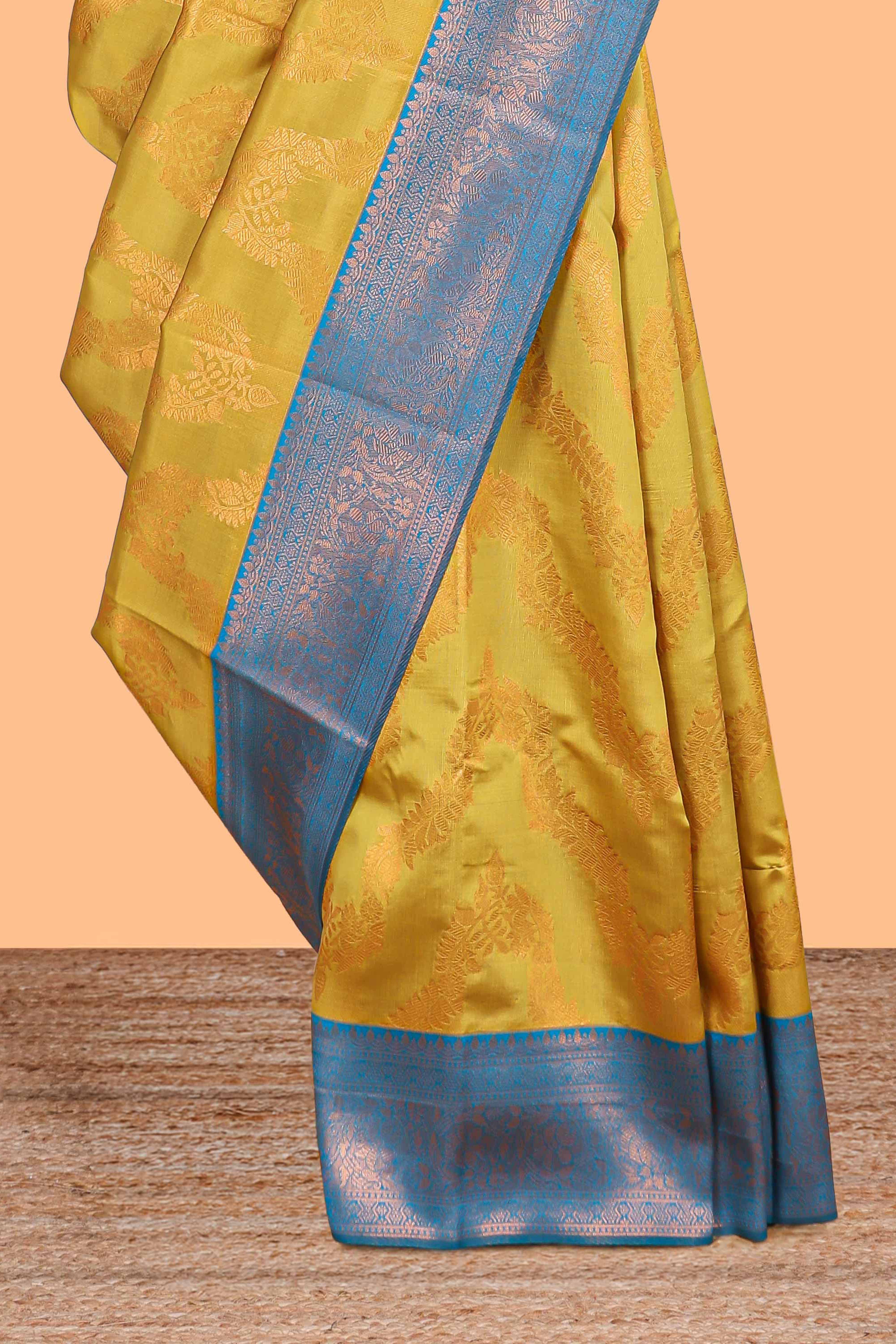 Mustard chevron zari design litchi silk saree with contrast zari design border and contrast blouse