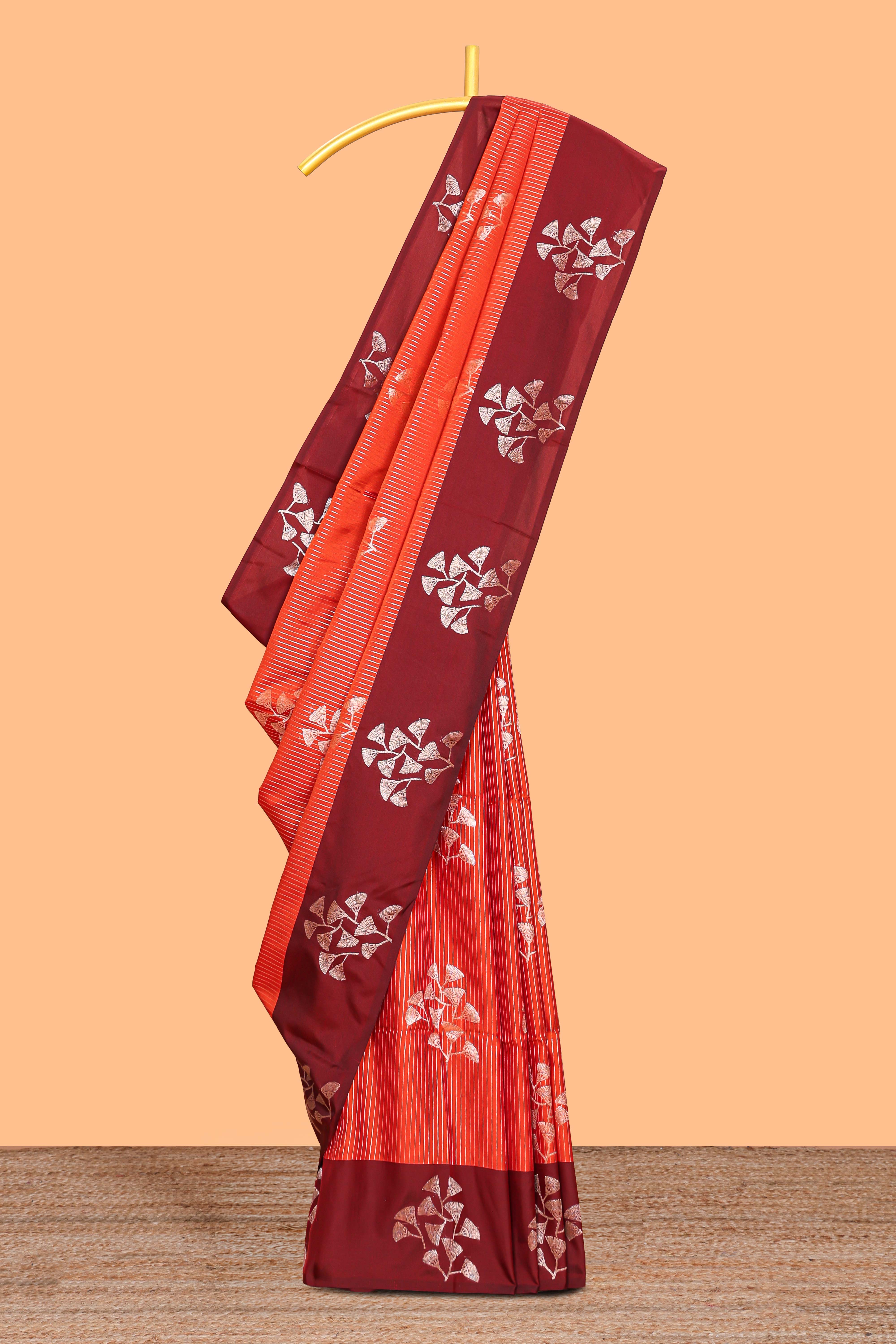 Orange striped floral zari design litchi silk saree with contrast zari design border and plain blouse