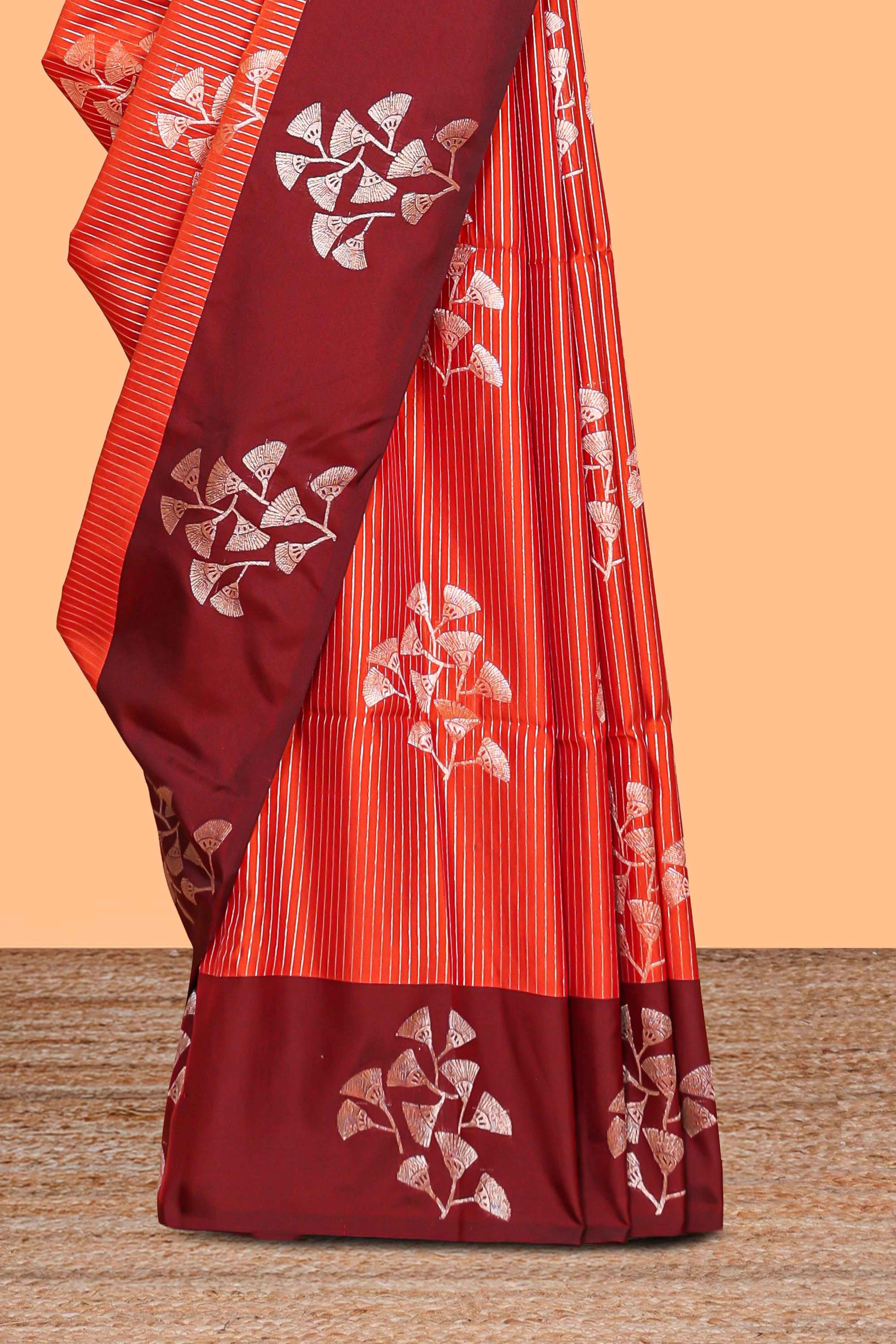 Orange striped floral zari design litchi silk saree with contrast zari design border and plain blouse