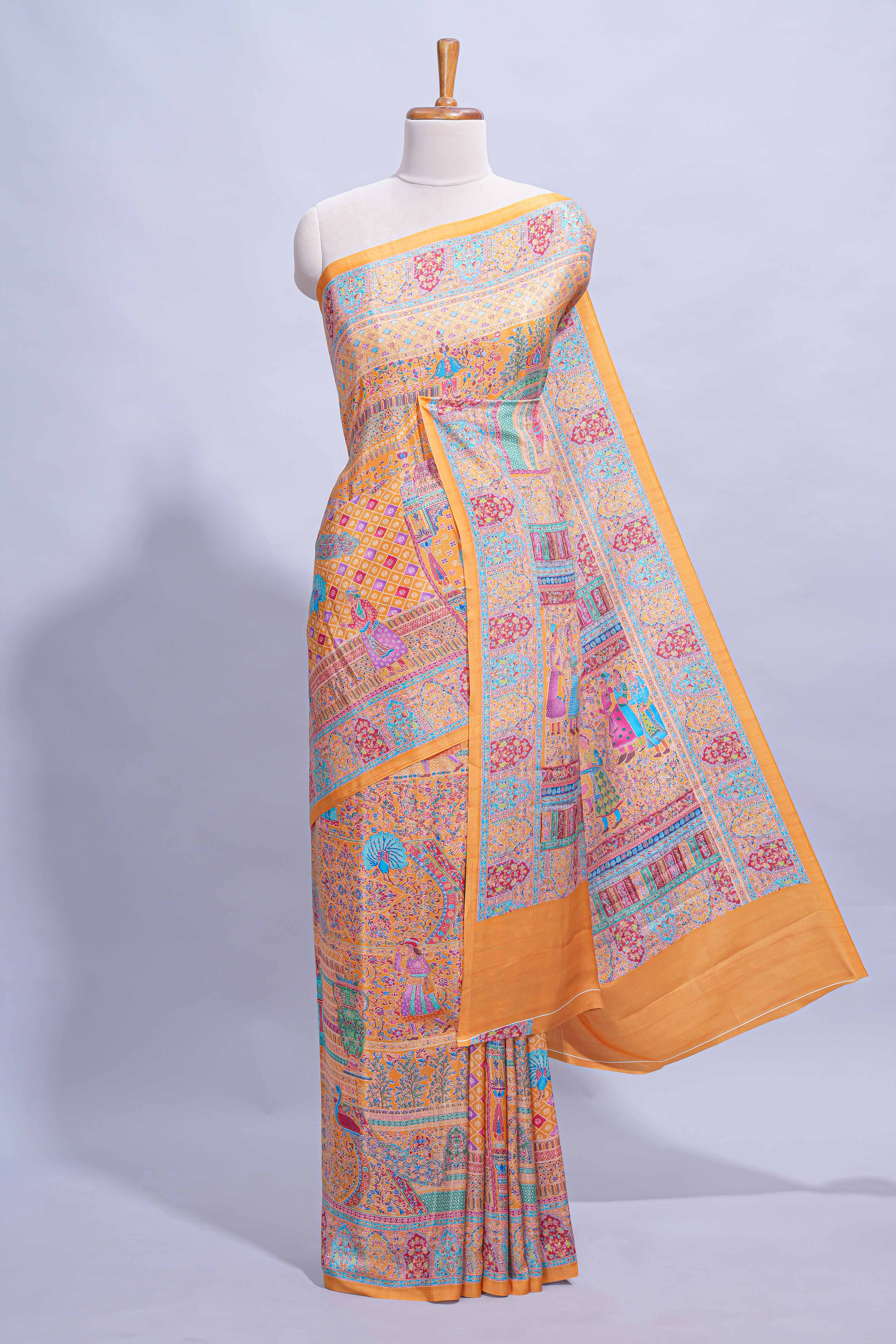 Orange colour mughal printed marsh mellow saree with self border and self printed pallu along with matching blouse
