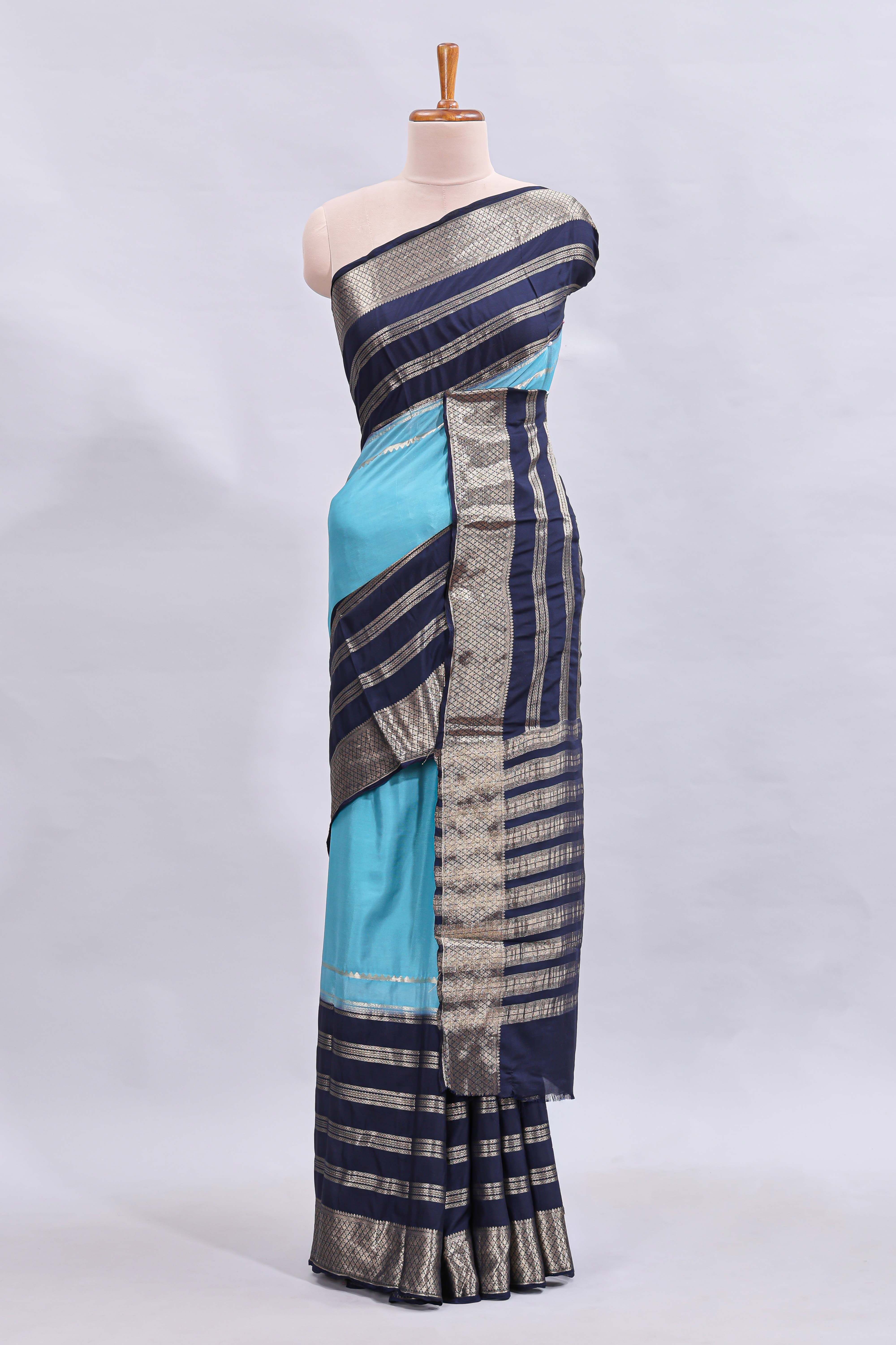 Blue zari design mushru silk saree with contrast striped zari border and blouse
