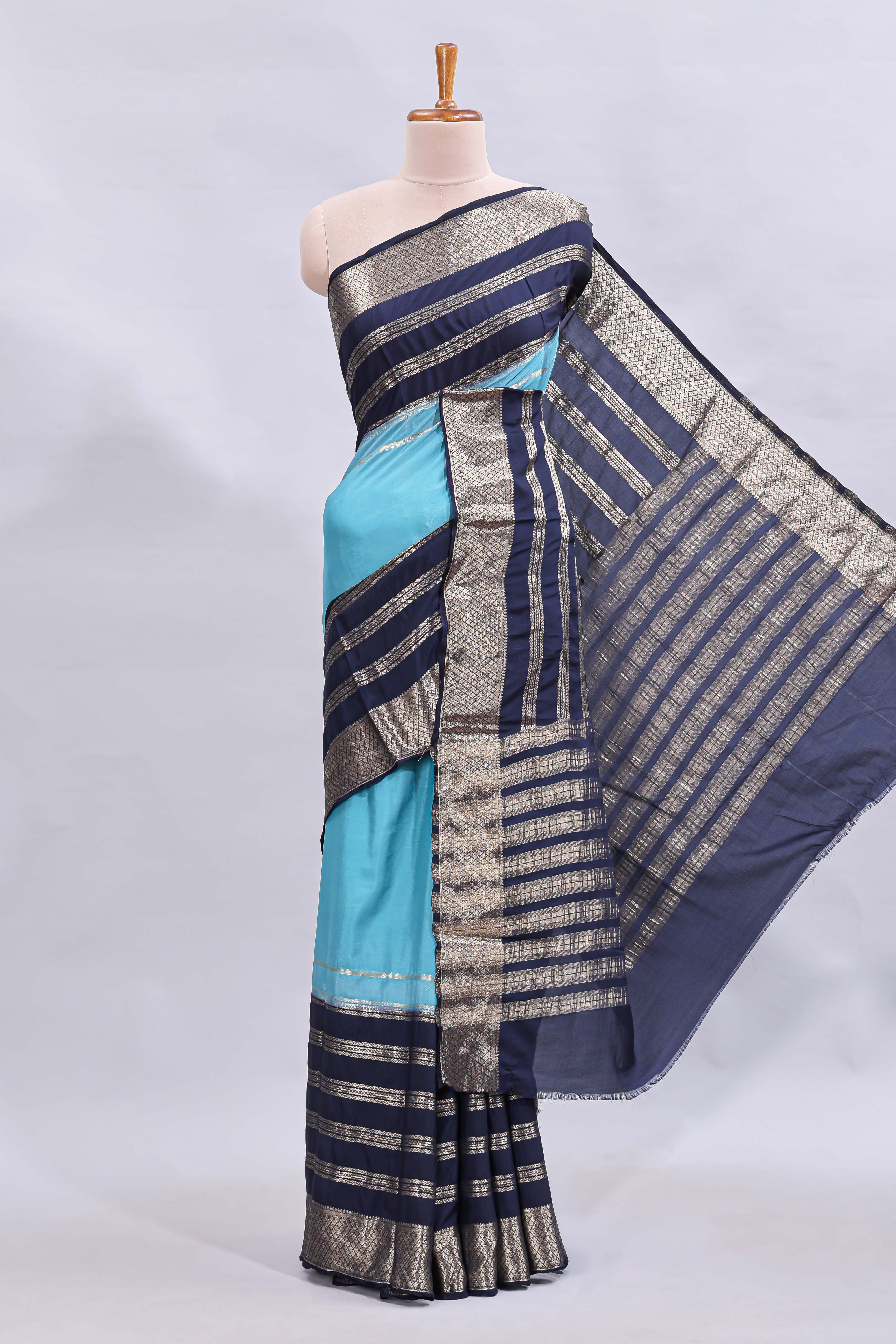 Blue zari design mushru silk saree with contrast striped zari border and blouse