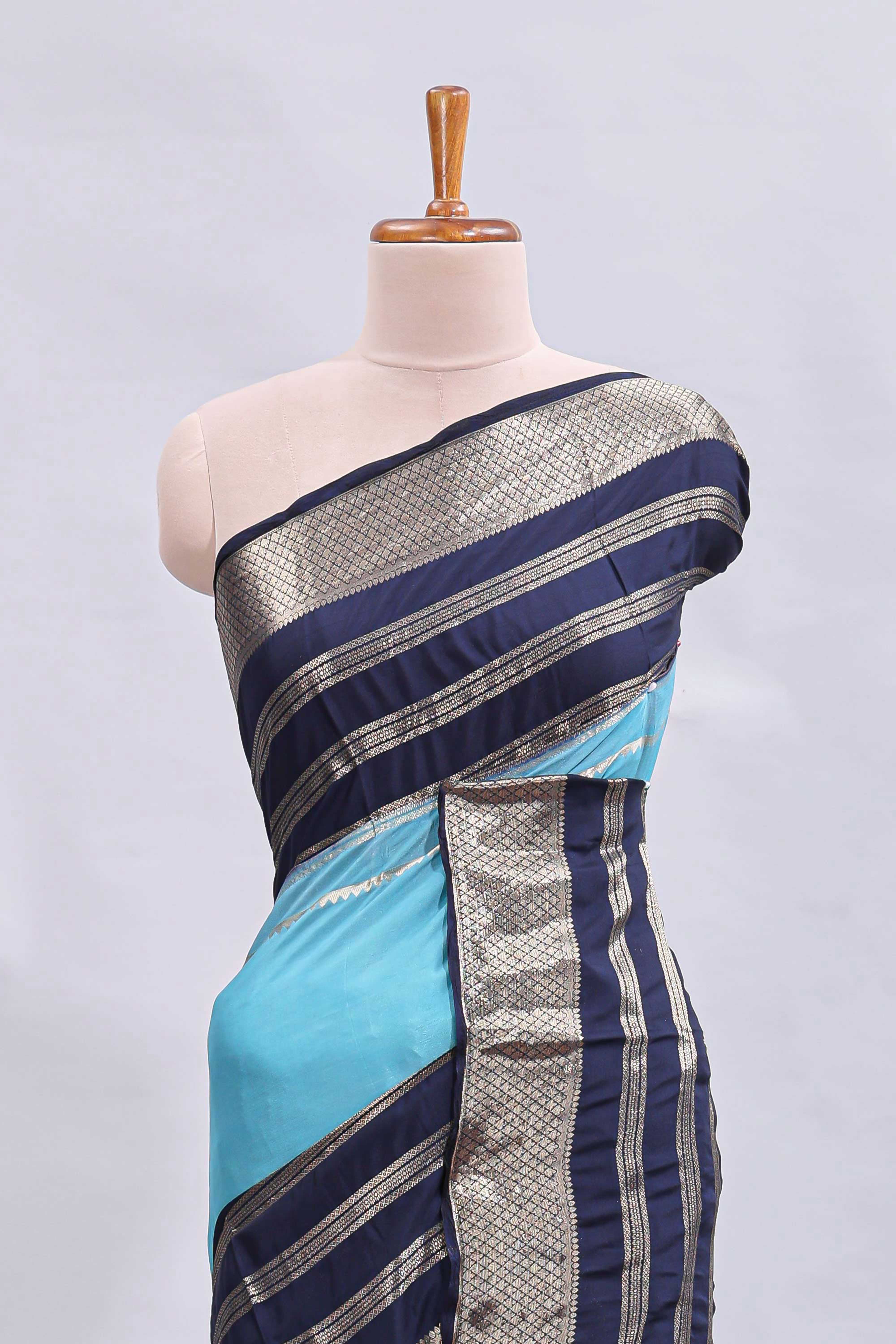 Blue zari design mushru silk saree with contrast striped zari border and blouse
