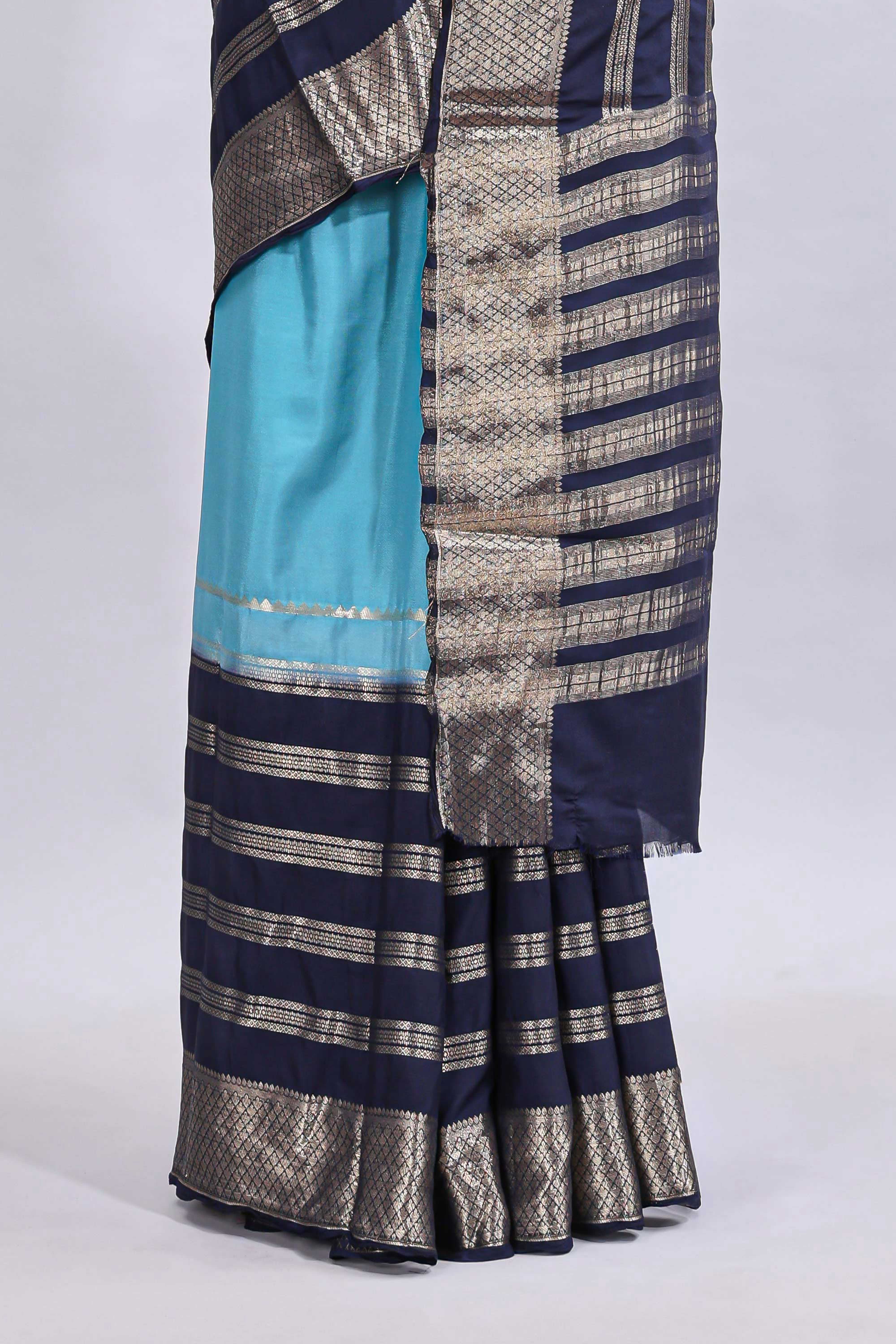 Blue zari design mushru silk saree with contrast striped zari border and blouse